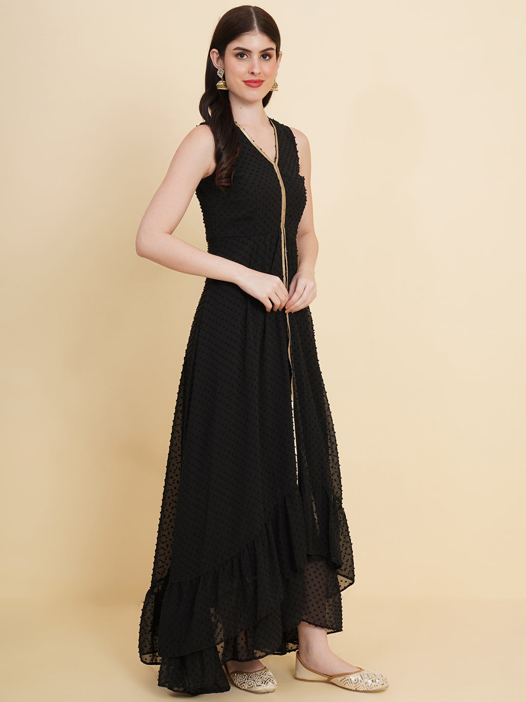 Black  colour long dress for women in georgette. Tailored with V-neck and high low pattern. Finished with a zip closure. It comes with a attached lining.