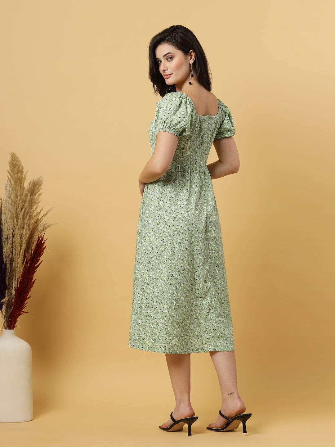 Sunshine in a dress! This flirty A-Line midi boasts a ruched bust, square neck, empire waist, and a flattering front slit – all adorned with gorgeous summer prints. 
Zip Closure at back.