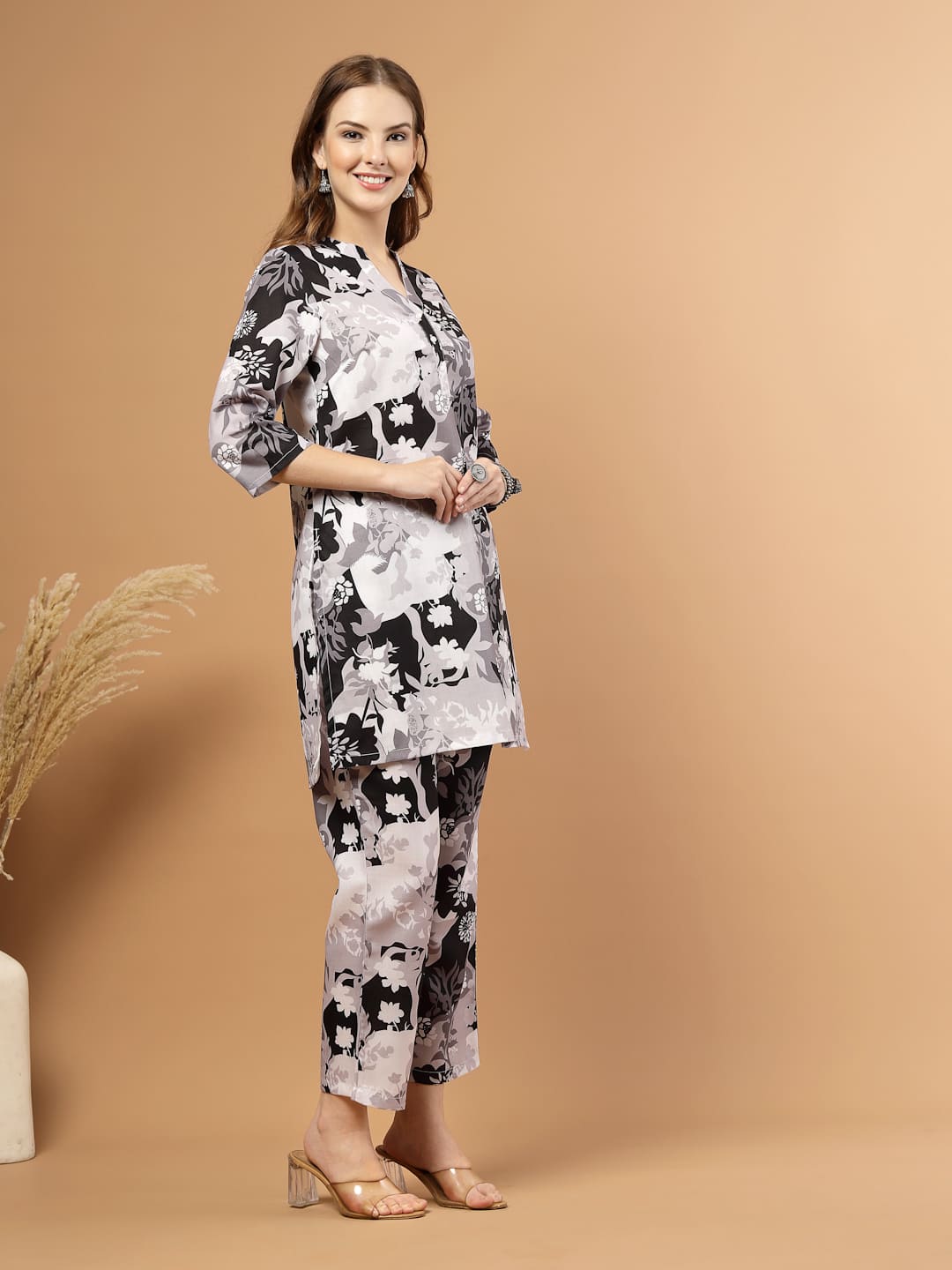 Black and white tropical printed kurta with matching bottoms, featuring soft breathable fabric and coordinated design for casual or festive wear. left side view.