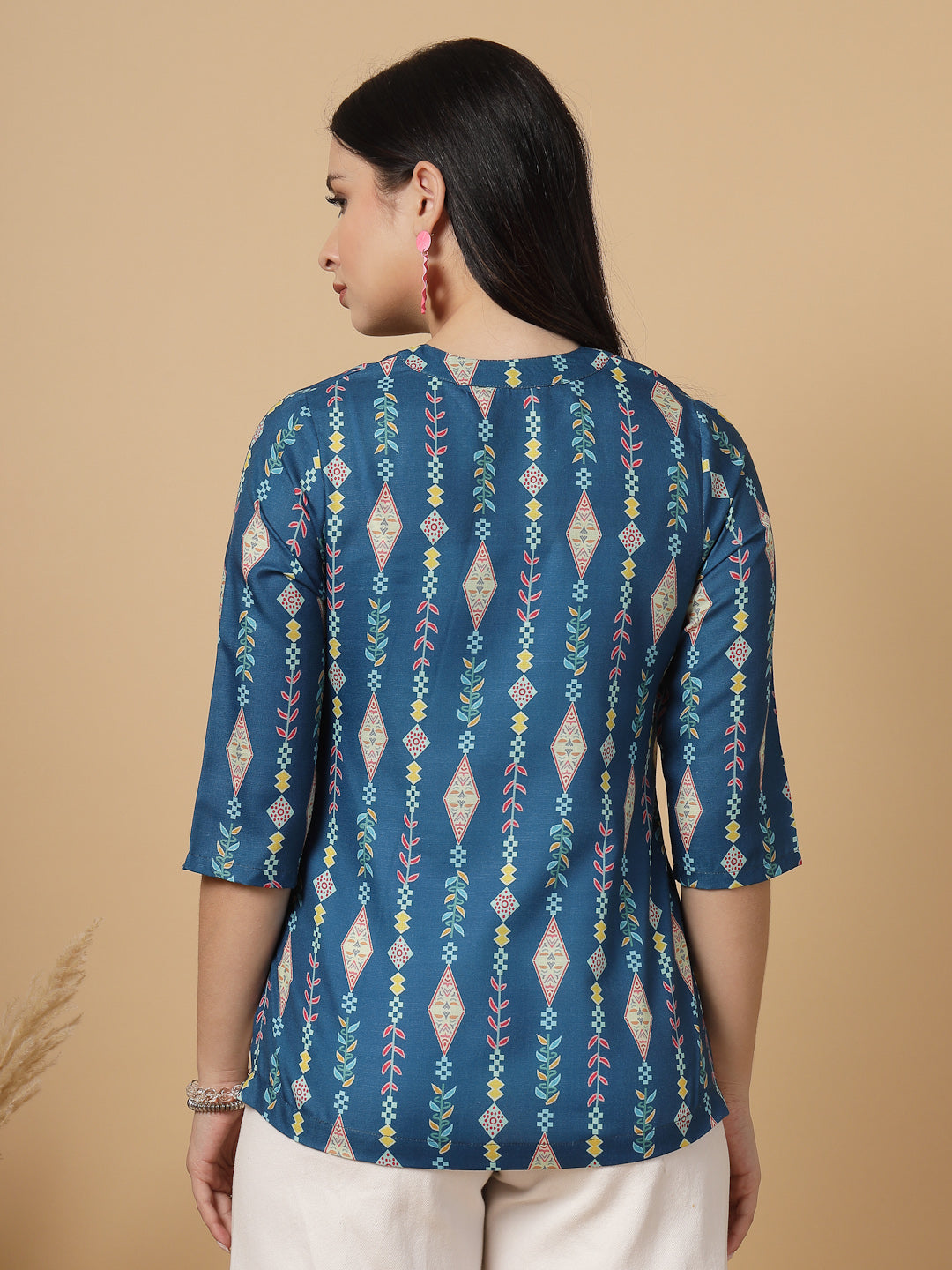 A modern take on a classic. This hip-length Printed kurta top offers a band collar, button-front, and a breezy, loose silhouette. Perfect, for office &amp; casual outings.

Dress it up or down for any occasion.

