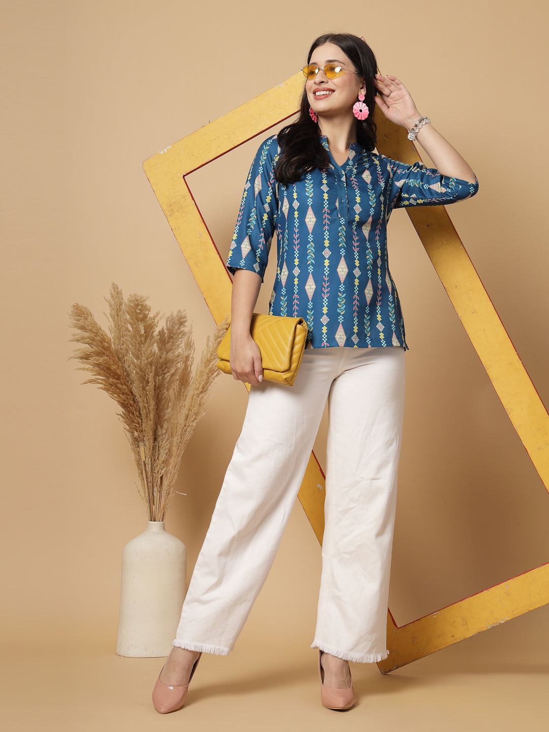 A modern take on a classic. This hip-length Printed kurta top offers a band collar, button-front, and a breezy, loose silhouette. Perfect, for office &amp; casual outings.

Dress it up or down for any occasion.

