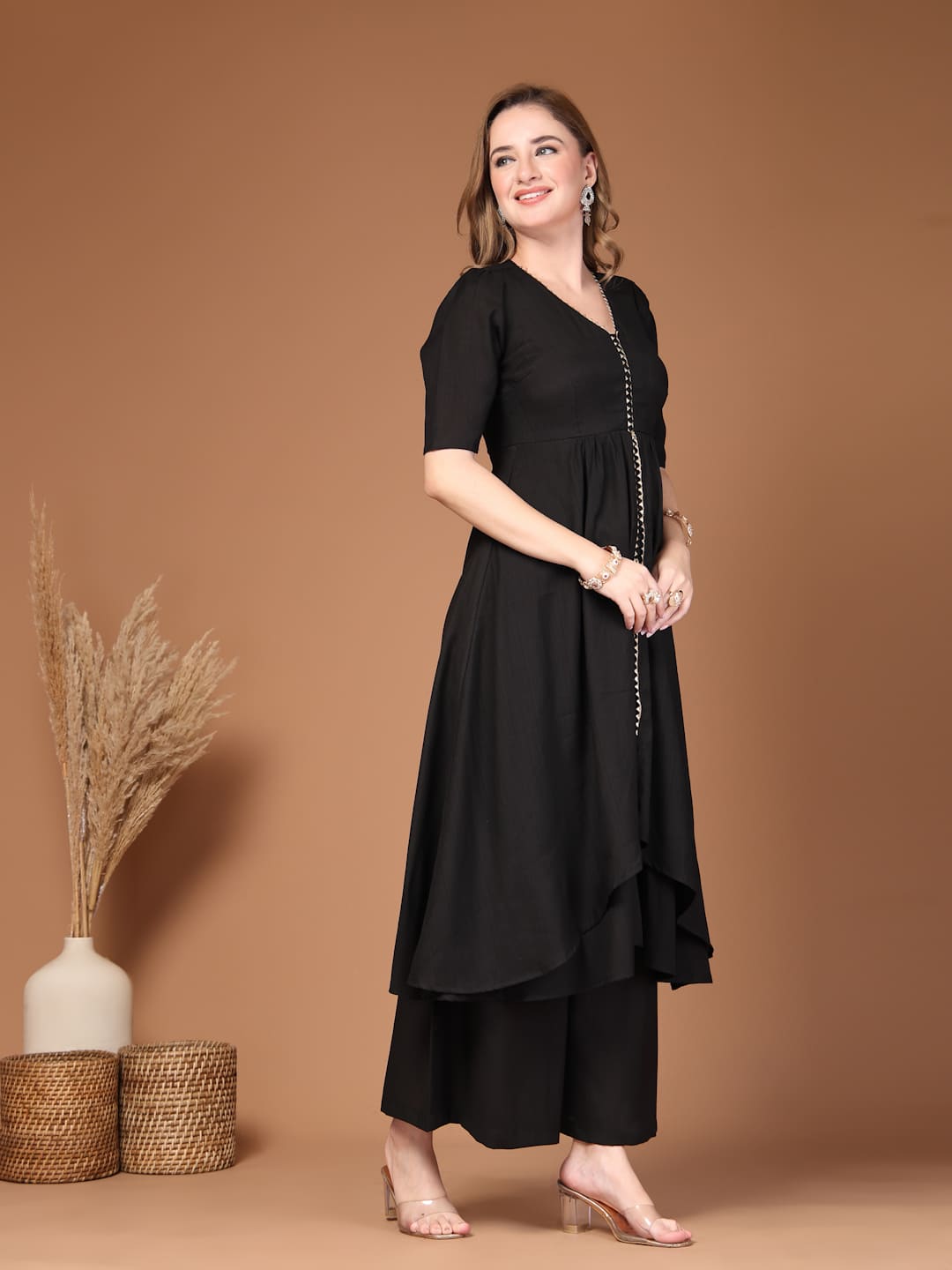 Women’s black layered kurta set with flared pants featuring a stylish silhouette, perfect for festive celebrations, parties and everyday ethnic wear-Side View