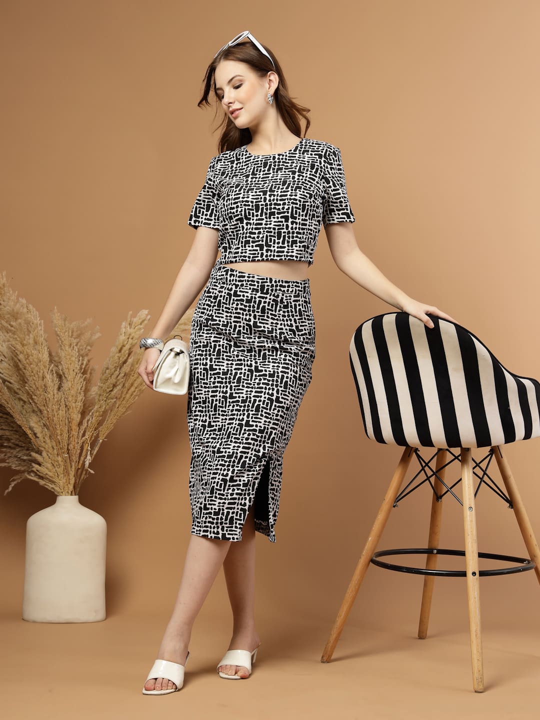 Black and white abstract printed women’s co-ord set featuring a blouson crop top paired with a straight skirt that has a stylish slit, perfect for a chic and modern look. Front view 