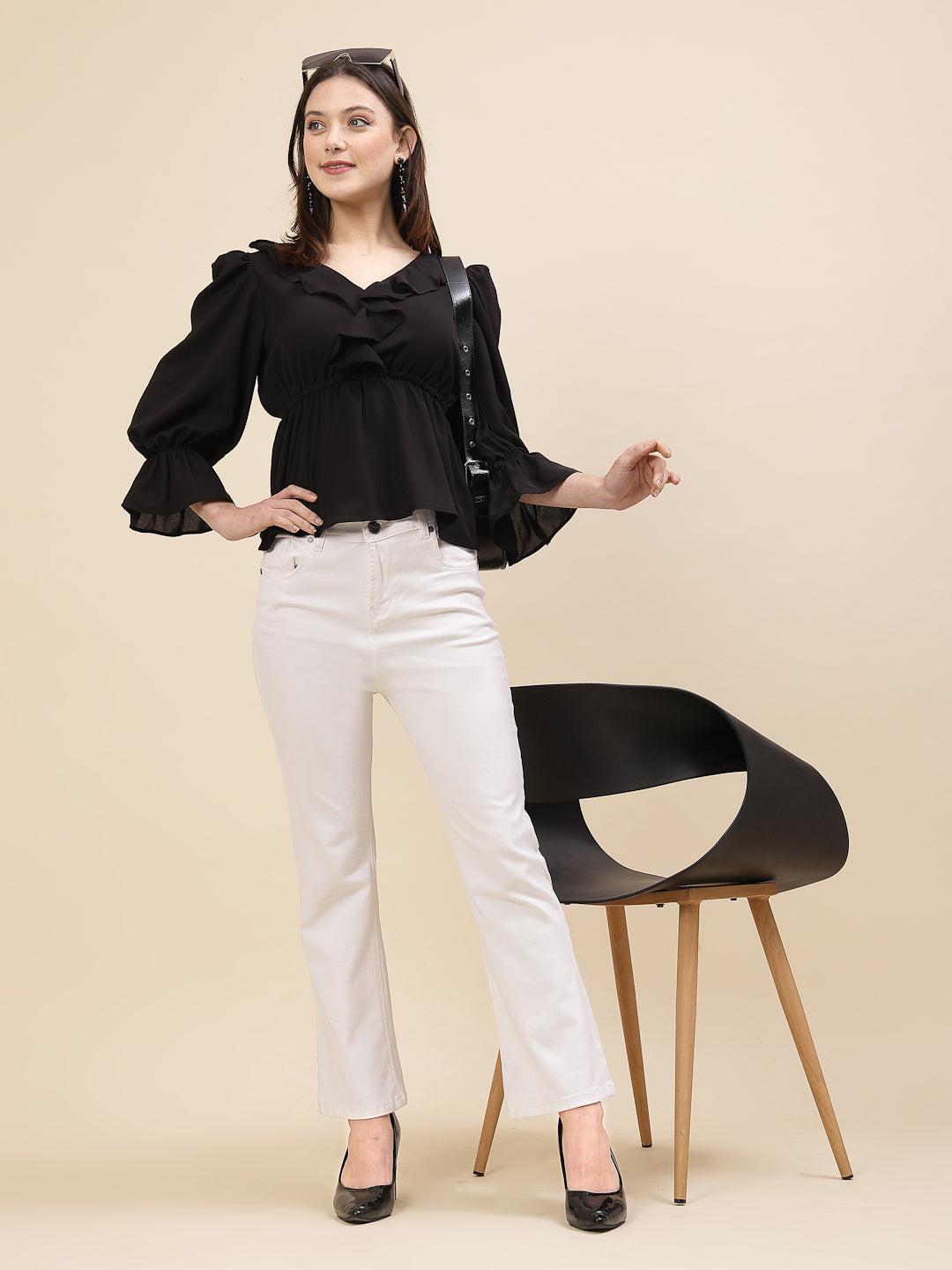 Black colour chic and sophisticated stylish top for women is a perfect blend of contemporary elegance and timeless charm. This exquisite piece features a beautifully ruffled neckline that adds a touch of romance and femininity to your ensemble. The ruched waist not only enhances your silhouette but also adds a modern twist, creating a flattering and fashionable look.