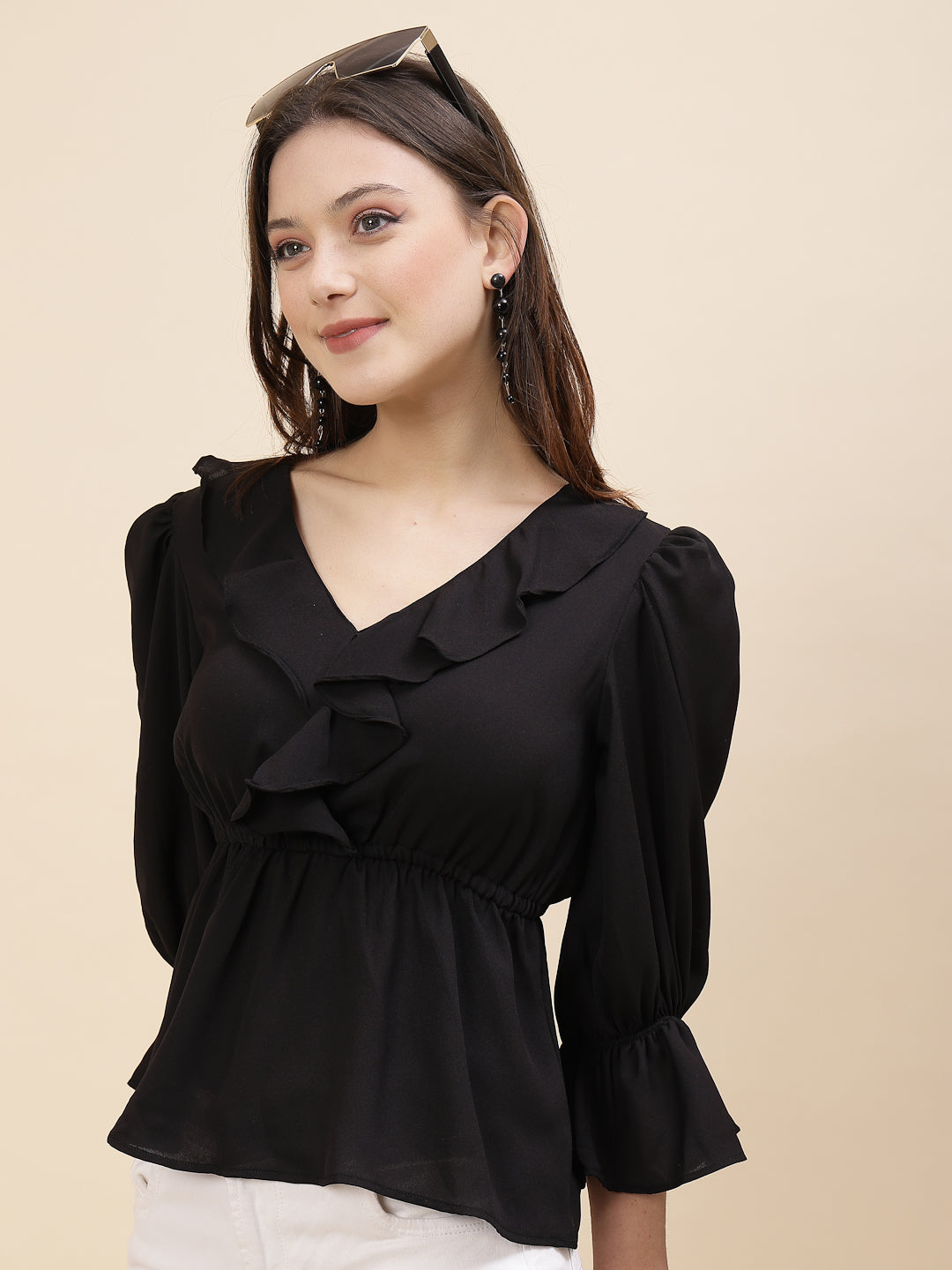 Black colour chic and sophisticated stylish top for women is a perfect blend of contemporary elegance and timeless charm. This exquisite piece features a beautifully ruffled neckline that adds a touch of romance and femininity to your ensemble. The ruched waist not only enhances your silhouette but also adds a modern twist, creating a flattering and fashionable look.