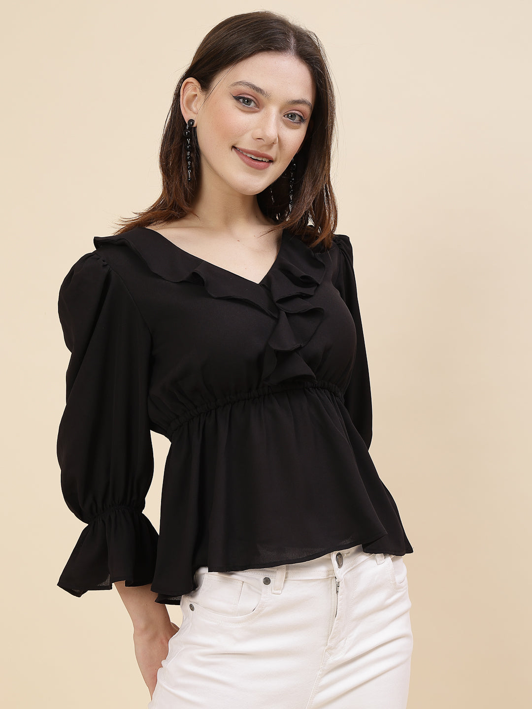 Black colour chic and sophisticated stylish top for women is a perfect blend of contemporary elegance and timeless charm. This exquisite piece features a beautifully ruffled neckline that adds a touch of romance and femininity to your ensemble. The ruched waist not only enhances your silhouette but also adds a modern twist, creating a flattering and fashionable look.