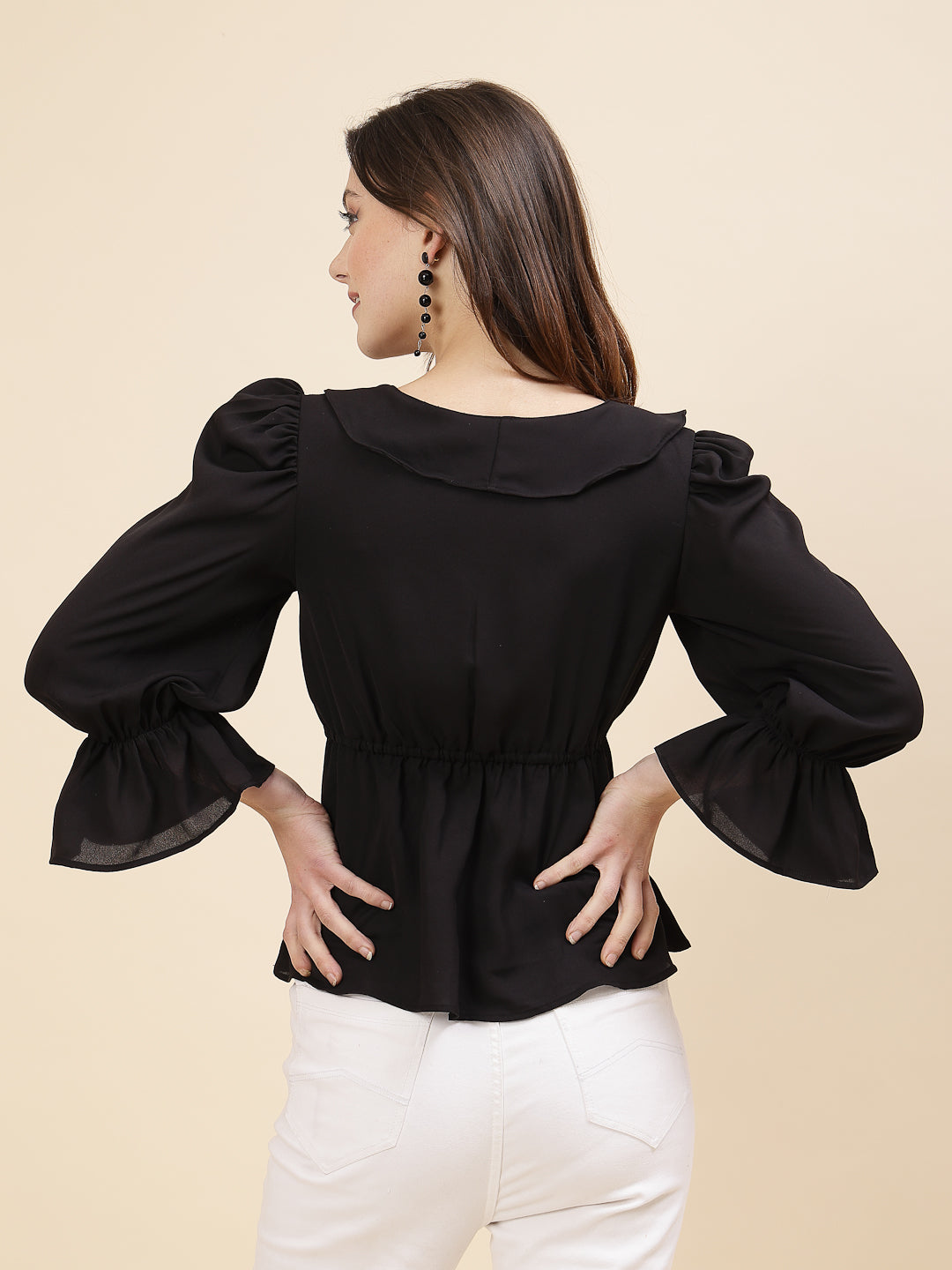 Black colour chic and sophisticated stylish top for women is a perfect blend of contemporary elegance and timeless charm. This exquisite piece features a beautifully ruffled neckline that adds a touch of romance and femininity to your ensemble. The ruched waist not only enhances your silhouette but also adds a modern twist, creating a flattering and fashionable look.