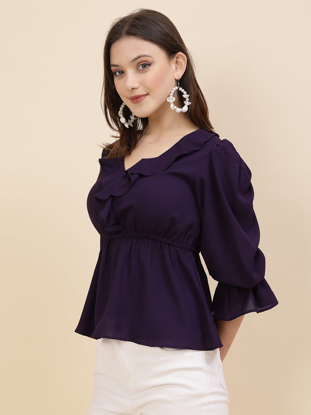 Chic and sophisticated stylish top for women is a perfect blend of contemporary elegance and timeless charm. This exquisite piece features a beautifully ruffled neckline that adds a touch of romance and femininity to your ensemble. The ruched waist not only enhances your silhouette but also adds a modern twist, creating a flattering and fashionable look.
