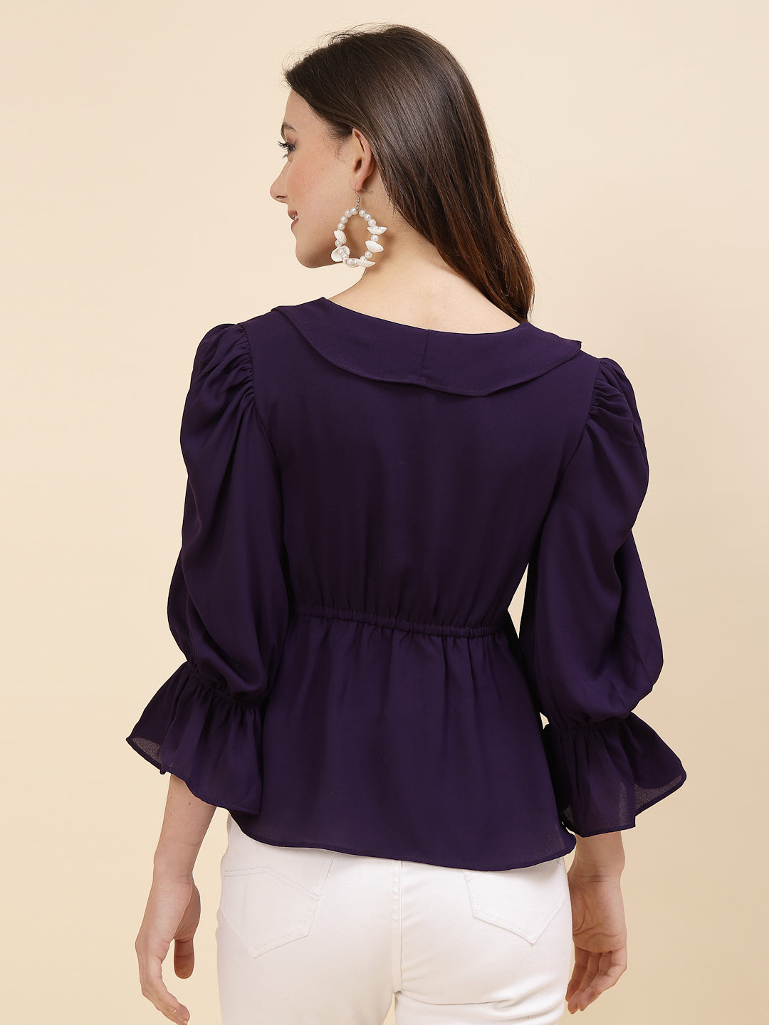 Chic and sophisticated stylish top for women is a perfect blend of contemporary elegance and timeless charm. This exquisite piece features a beautifully ruffled neckline that adds a touch of romance and femininity to your ensemble. The ruched waist not only enhances your silhouette but also adds a modern twist, creating a flattering and fashionable look.