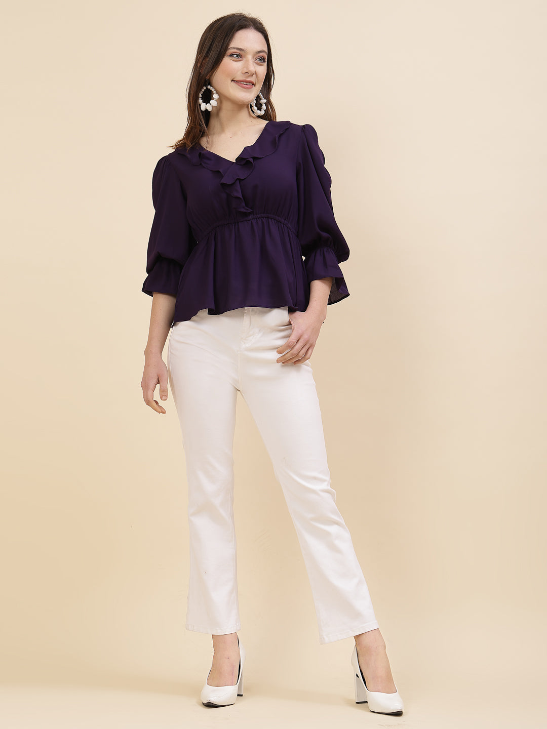 Chic and sophisticated stylish top for women is a perfect blend of contemporary elegance and timeless charm. This exquisite piece features a beautifully ruffled neckline that adds a touch of romance and femininity to your ensemble. The ruched waist not only enhances your silhouette but also adds a modern twist, creating a flattering and fashionable look.