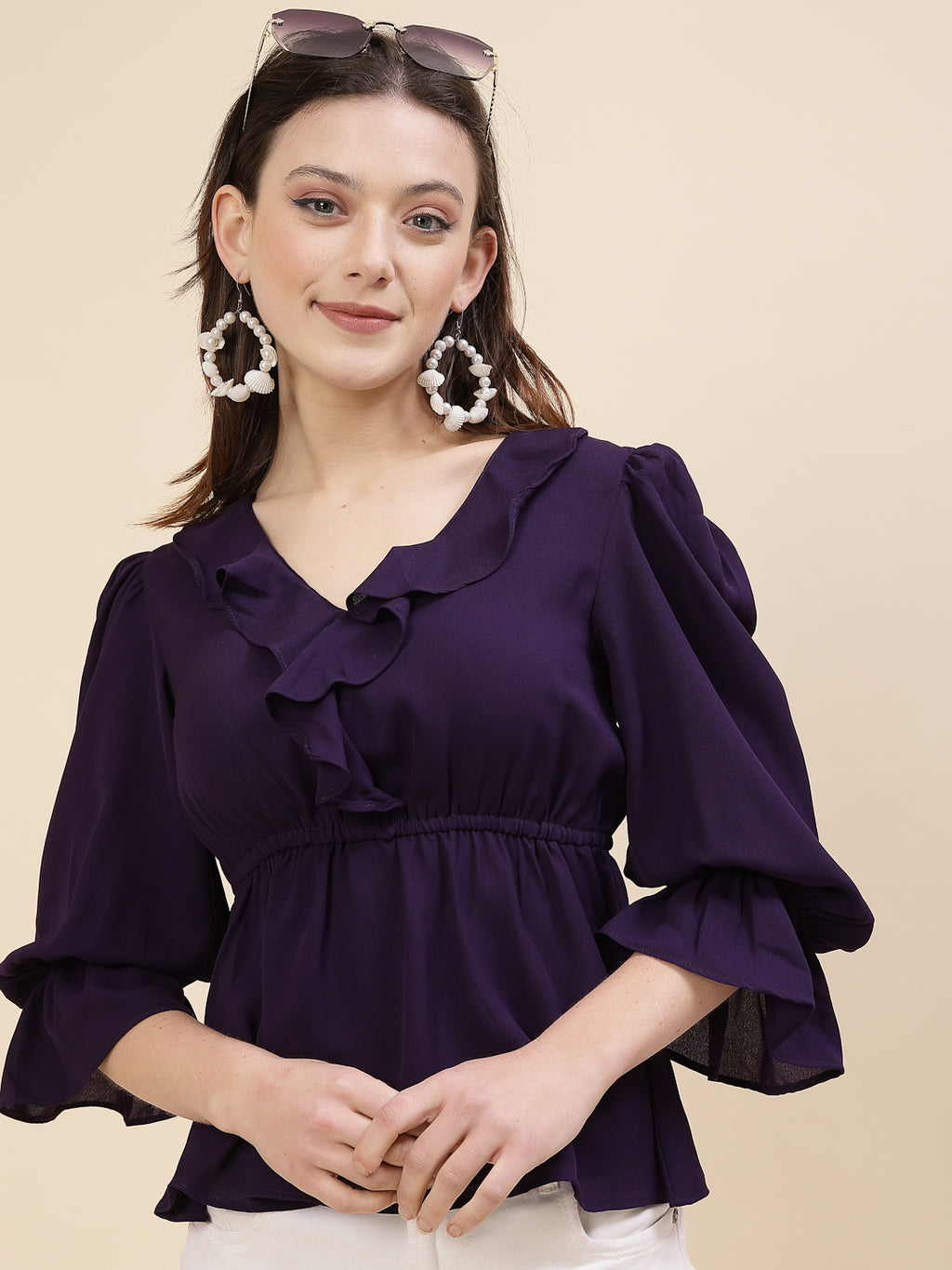 Chic and sophisticated stylish top for women is a perfect blend of contemporary elegance and timeless charm. This exquisite piece features a beautifully ruffled neckline that adds a touch of romance and femininity to your ensemble. The ruched waist not only enhances your silhouette but also adds a modern twist, creating a flattering and fashionable look.