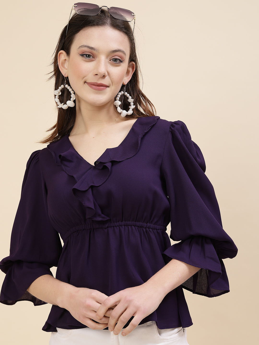 Chic and sophisticated stylish top for women is a perfect blend of contemporary elegance and timeless charm. This exquisite piece features a beautifully ruffled neckline that adds a touch of romance and femininity to your ensemble. The ruched waist not only enhances your silhouette but also adds a modern twist, creating a flattering and fashionable look.