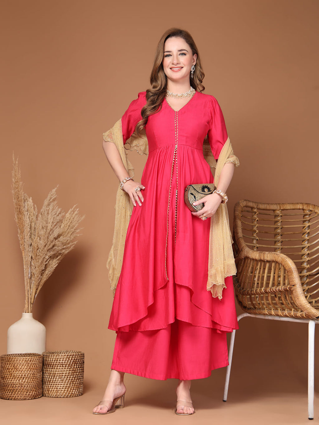 Women’s pink layered kurta set with flared pants, stylish Indian ethnic wear for celebrations and daily wear.