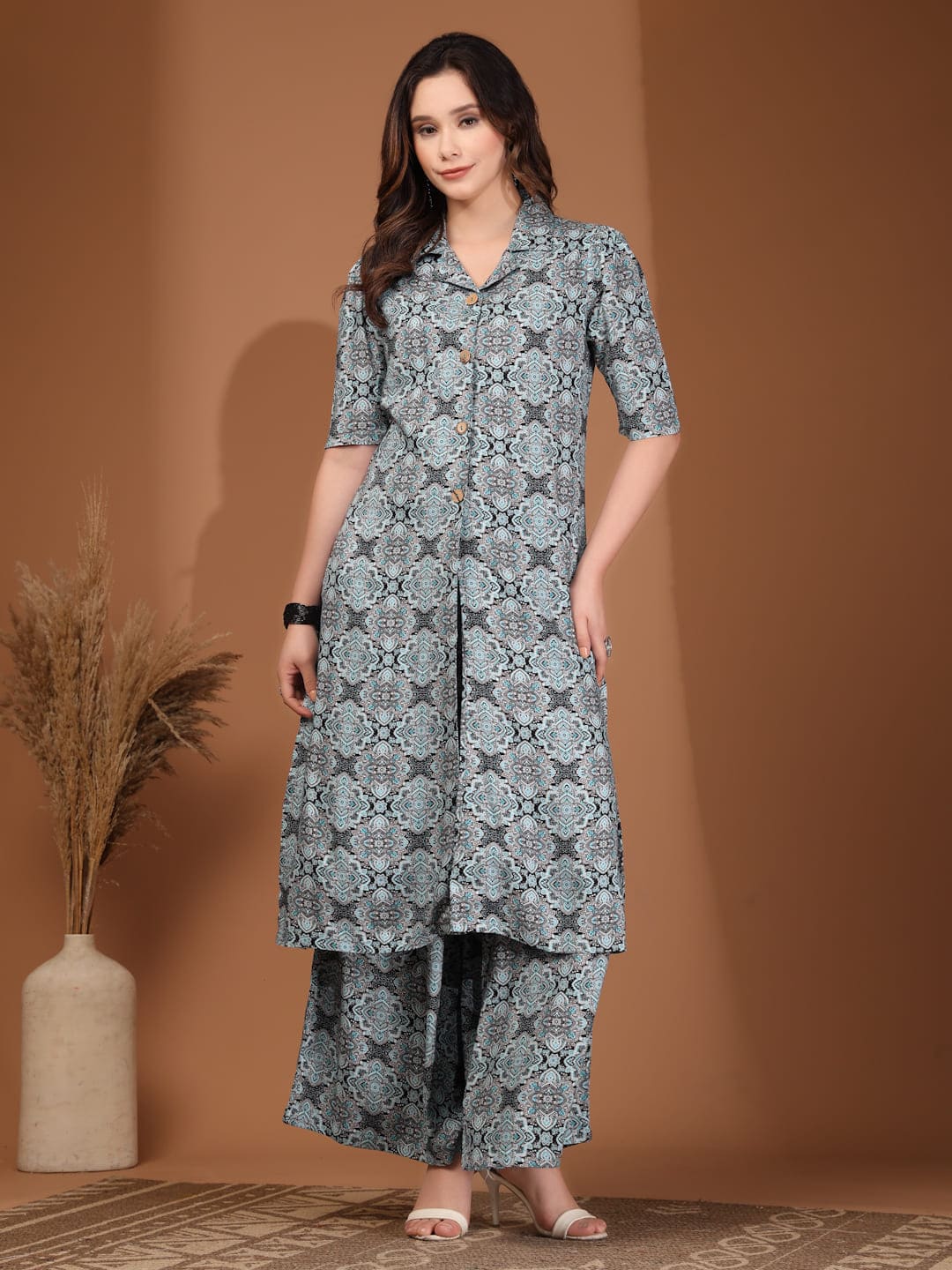 Woman wearing a blue and grey geometric printed long tunic top with a front slit and matching wide-leg palazzo pants front image