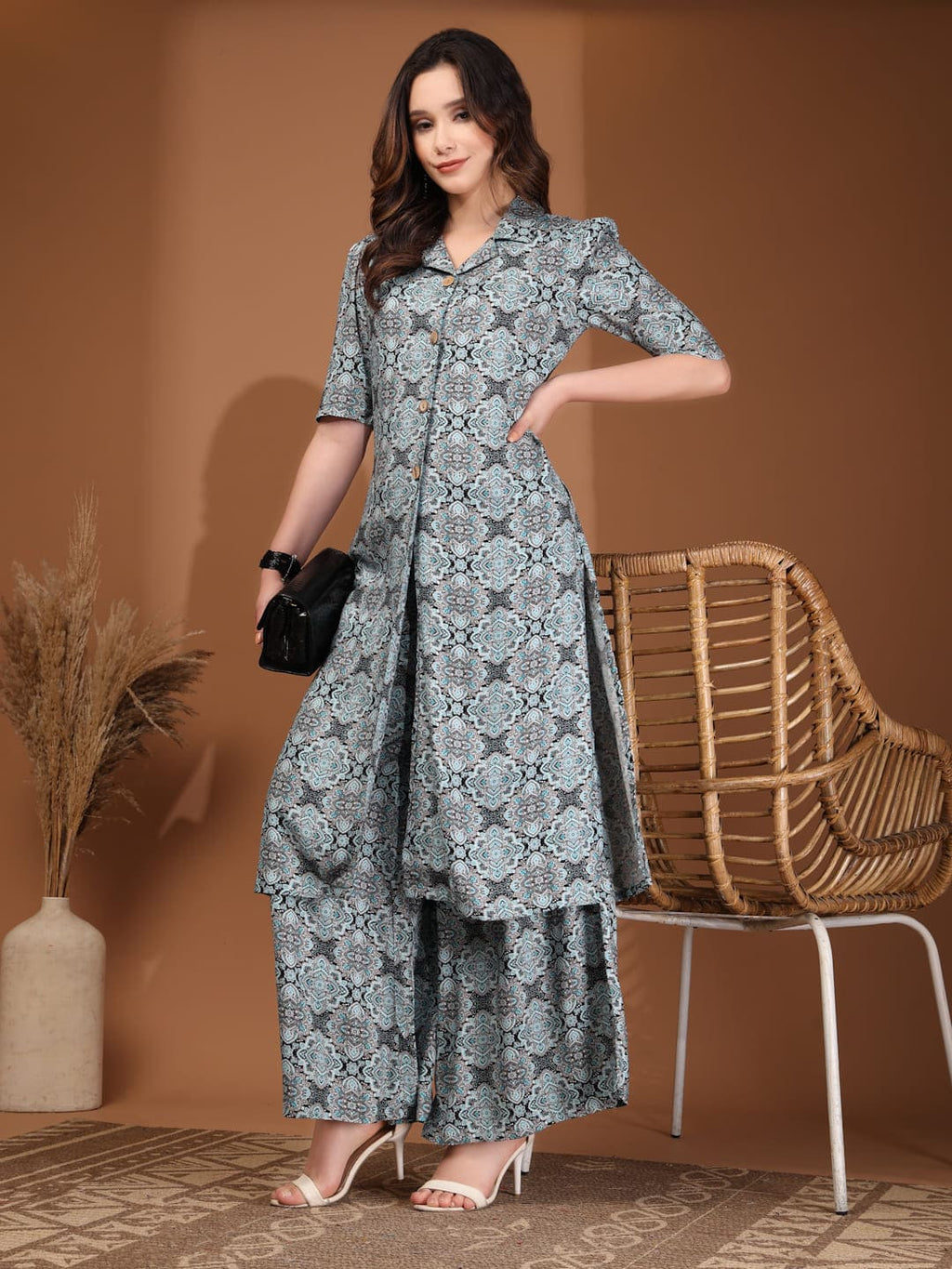 Woman wearing a blue and grey geometric printed long tunic top with a front slit and matching wide-leg palazzo pants styling image