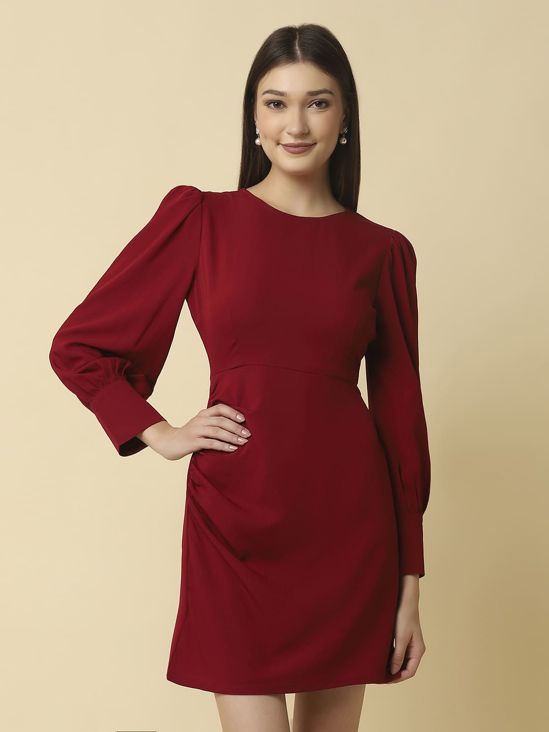 Woman wearing Raassio maroon ruched short dress with long puff sleeves facing front View