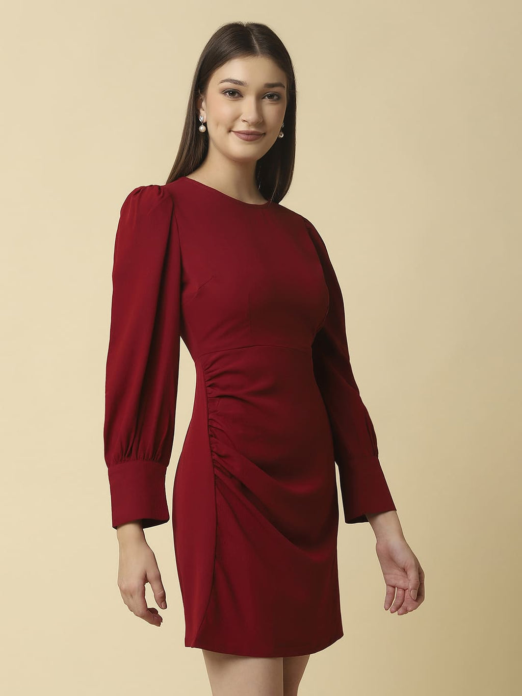 Woman wearing Raassio maroon ruched short dress with long puff sleeves facing front right side View