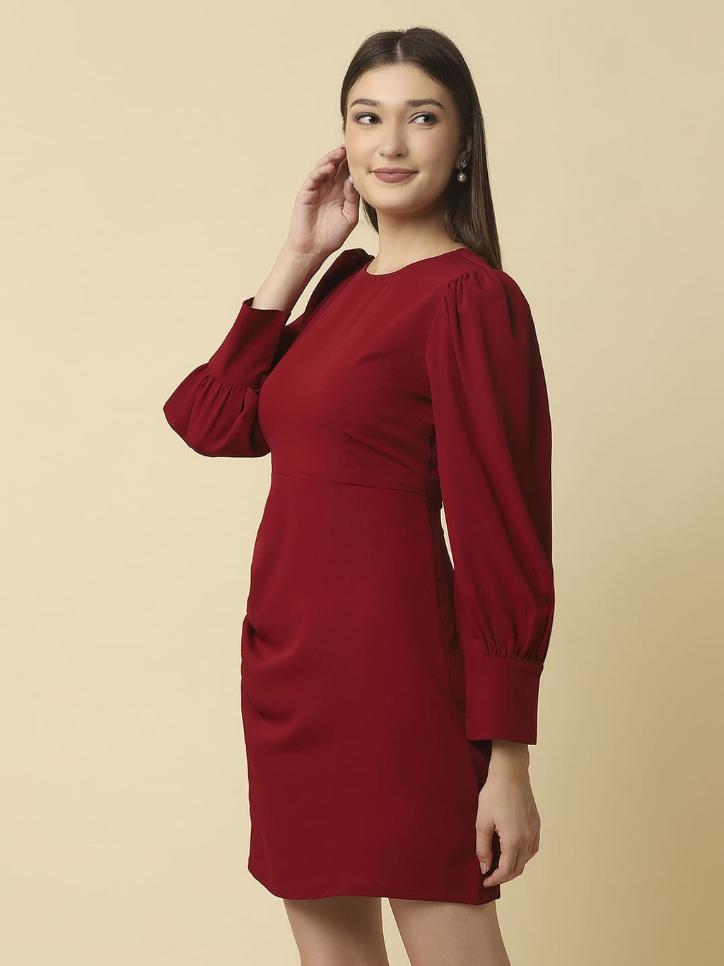 Woman wearing Raassio maroon ruched short dress with long puff sleeves facing front left View