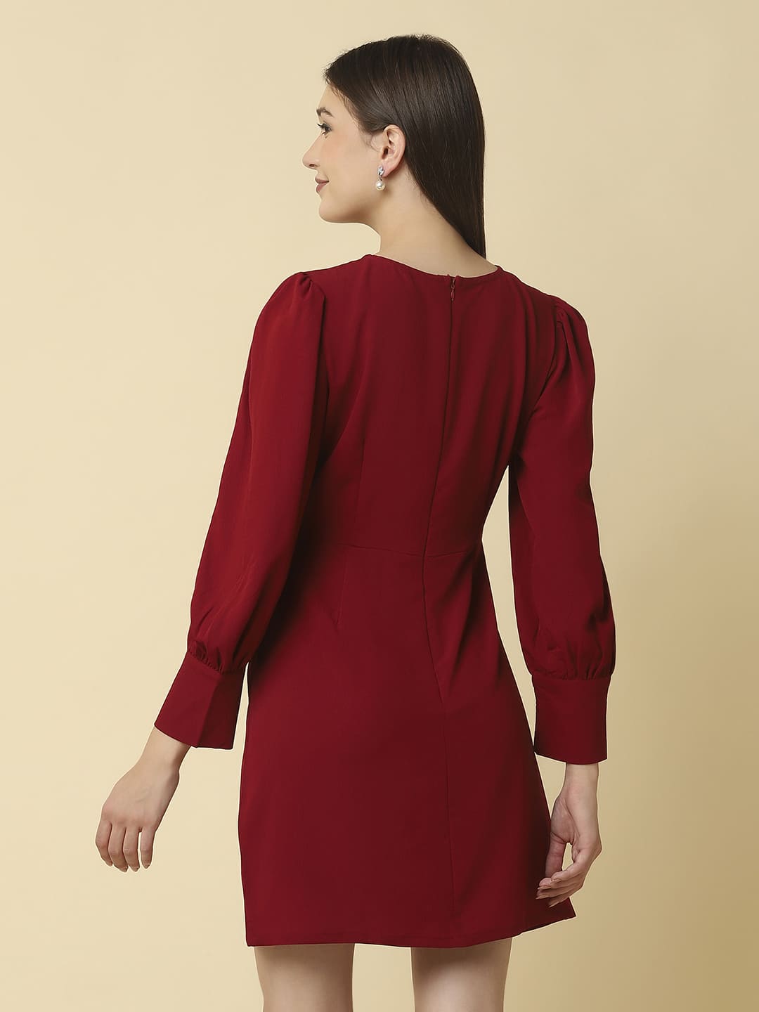 Woman wearing Raassio maroon ruched short dress with long puff sleeves facing back View