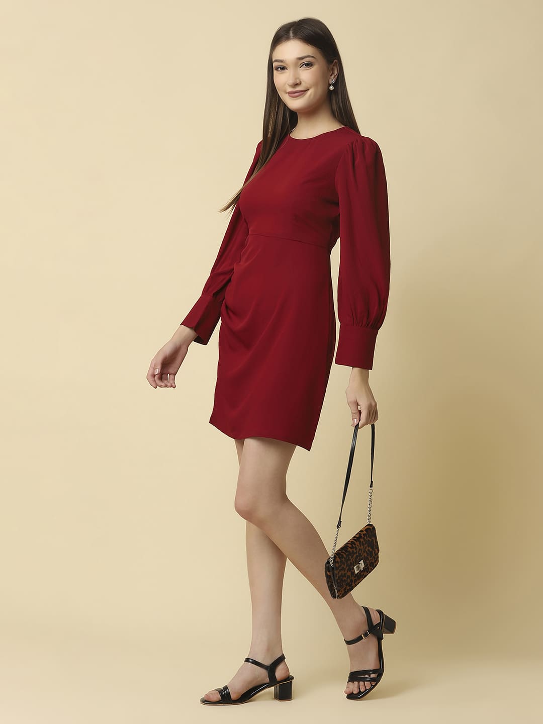 Woman wearing Raassio maroon ruched short dress with long puff sleeves facing front styled image