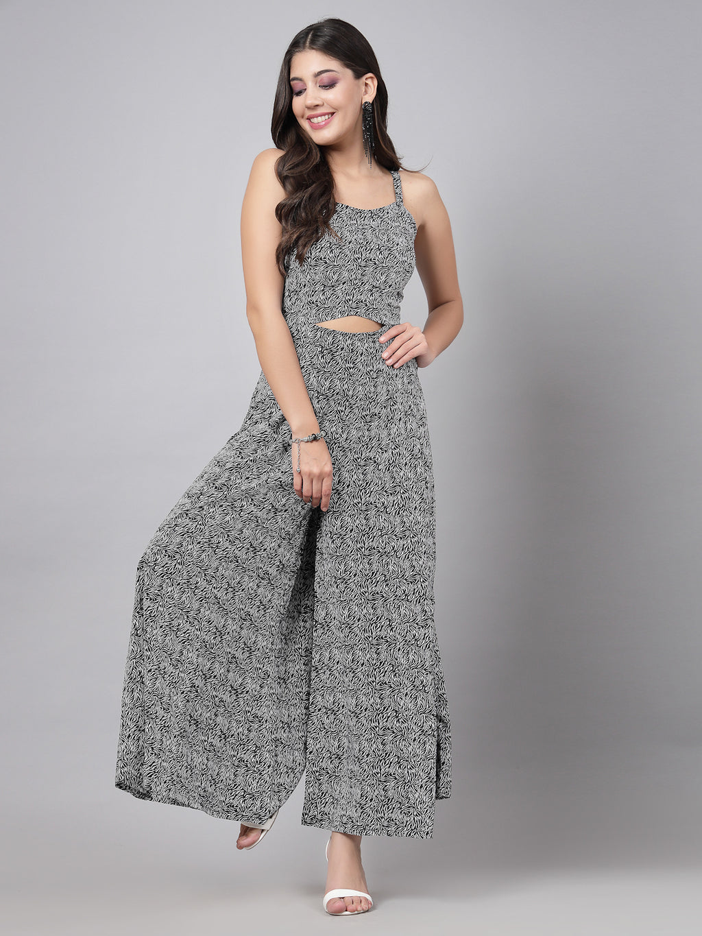     This stunning and playful black print jumpsuit for women & girls with a stylish cut at the waist is what your wardrobe just needs ! Complete your look with a pair of heels and a sling.   Colour : Black  Print : All over Print  Material : Crepe  Sleeve : Sleeveless  Zip Closure at Back   