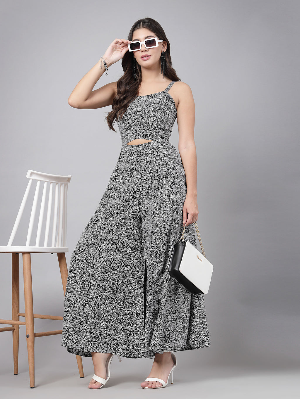     This stunning and playful black print jumpsuit for women & girls with a stylish cut at the waist is what your wardrobe just needs ! Complete your look with a pair of heels and a sling.   Colour : Black  Print : All over Print  Material : Crepe  Sleeve : Sleeveless  Zip Closure at Back   