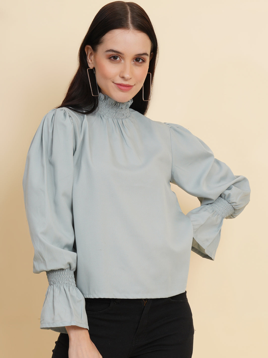 A stylish women's top in a soft shade of grey. The top features smocked detailing on both the full sleeves and the neck band, adding a touch of elegance and texture to the design.