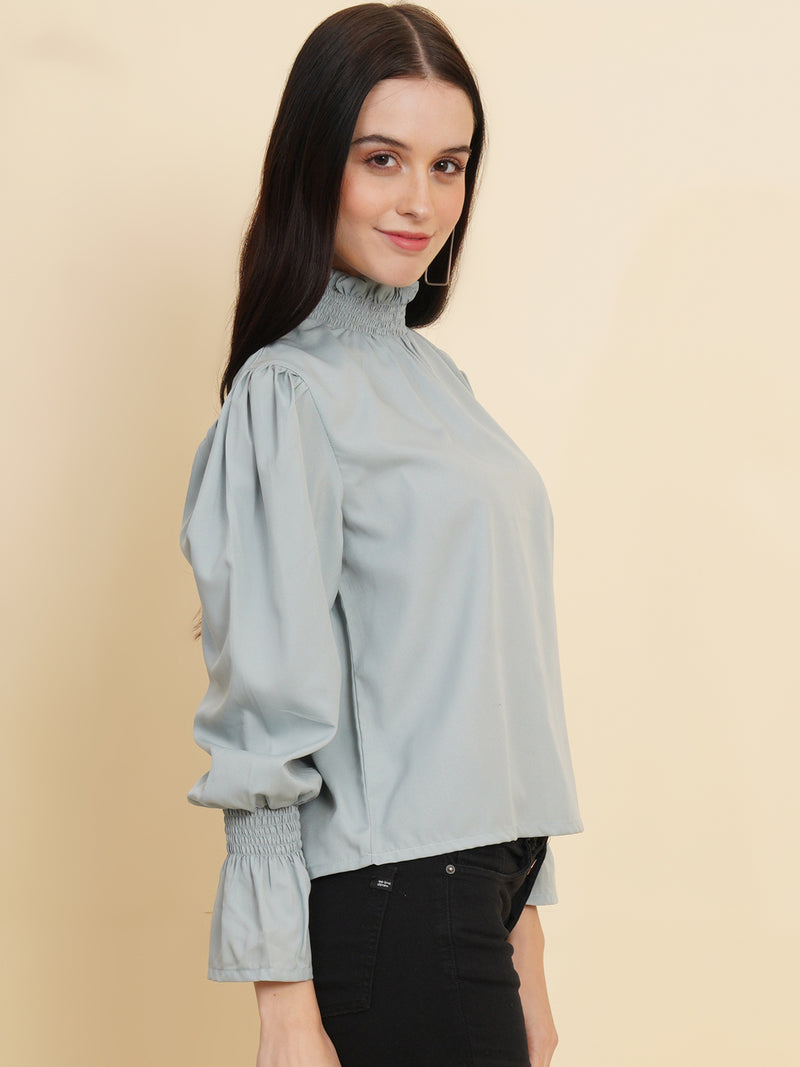 A stylish women's top in a soft shade of grey. The top features smocked detailing on both the full sleeves and the neck band, adding a touch of elegance and texture to the design.