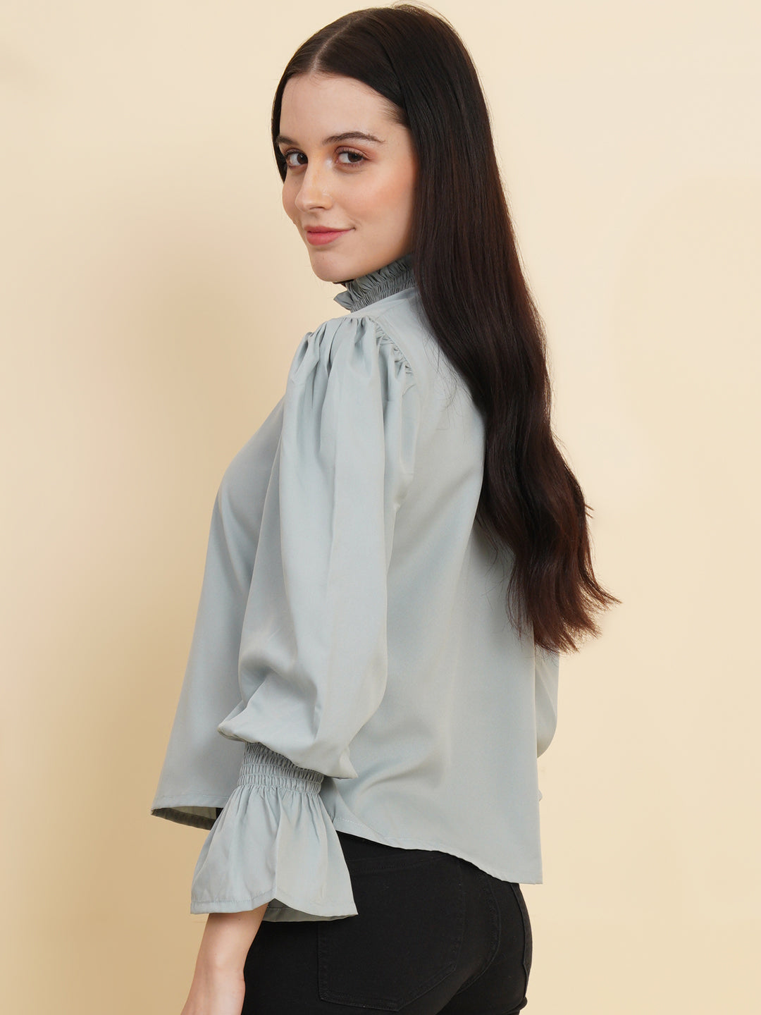 A stylish women's top in a soft shade of grey. The top features smocked detailing on both the full sleeves and the neck band, adding a touch of elegance and texture to the design.