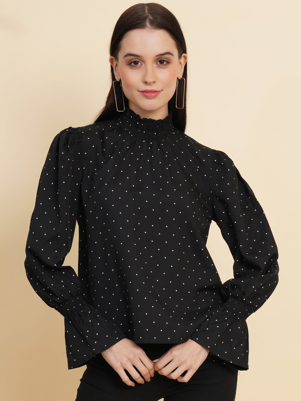An elegant black women's top with a stylish dotted print. The top features a smocked neck and sleeves, adding a touch of sophistication and charm to your outfit