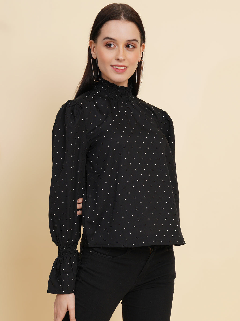 An elegant black women's top with a stylish dotted print. The top features a smocked neck and sleeves, adding a touch of sophistication and charm to your outfit
