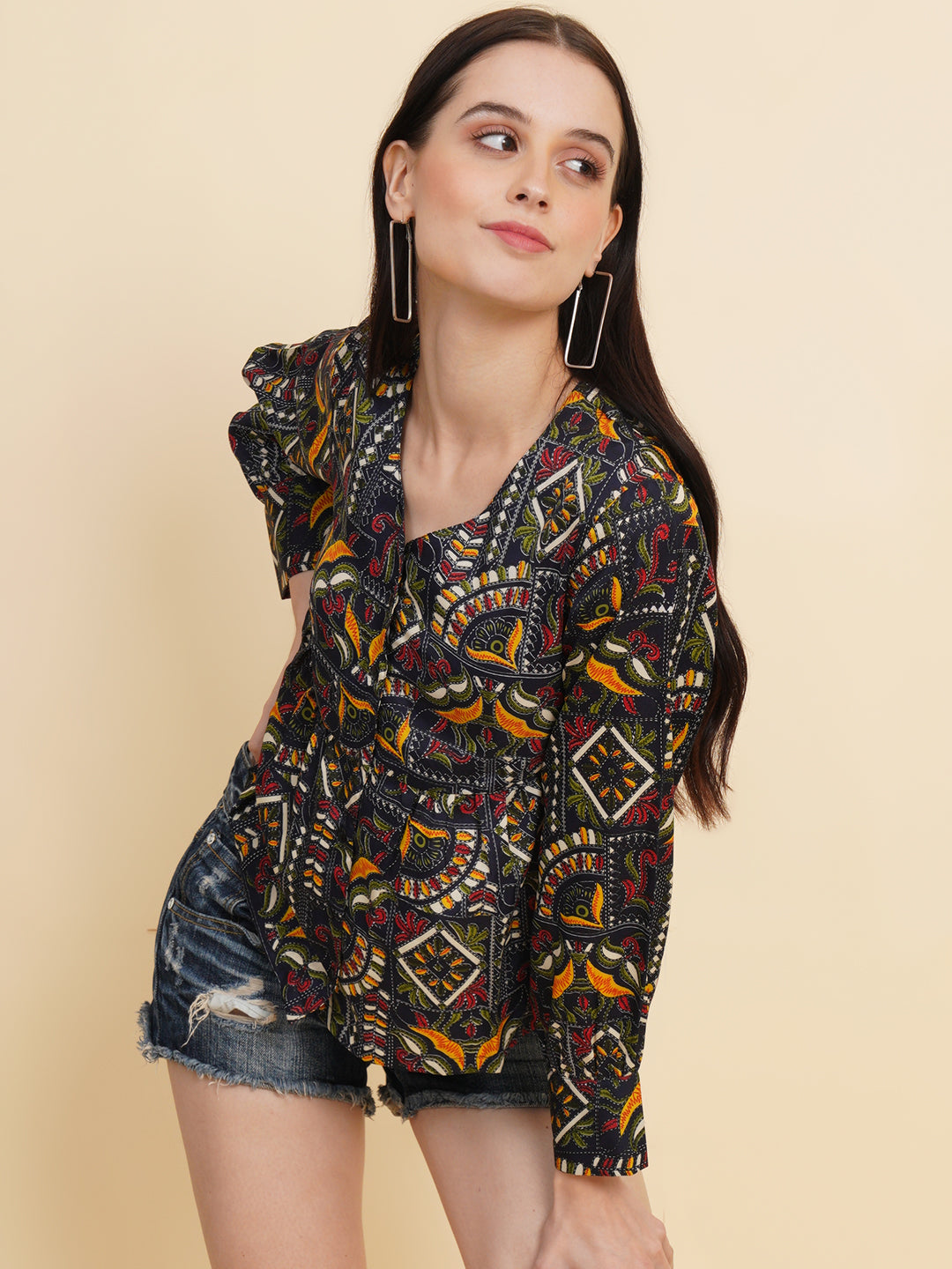 A vibrant and stylish women's top with a multi-color ethnic print. The top features full sleeves and is made with high-quality fabric. The print consists of various intricate patterns and colors, creating a visually appealing and unique design. The top is suitable for casual or semi-formal occasions, adding a touch of cultural flair to any outfit