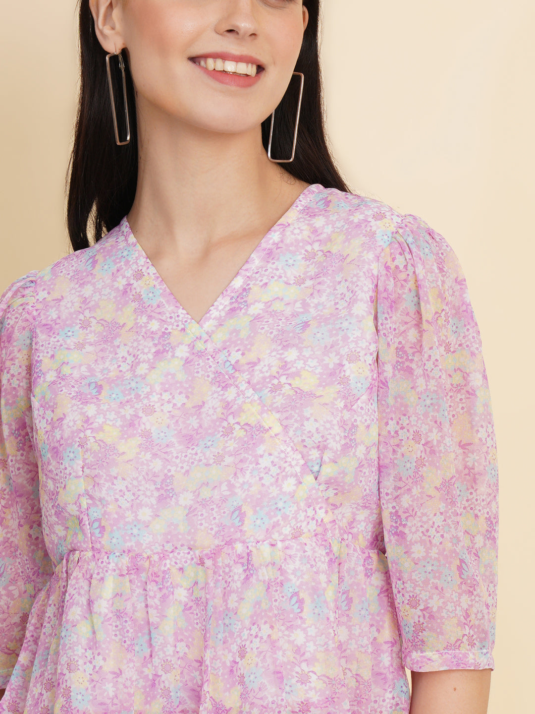  A vibrant purple women's top adorned with beautiful floral patterns. It features double ruffle detailing, creating an elegant and feminine look. The top is fully lined, providing comfort and a smooth fit. Perfect for adding a touch of color and style to any outfit