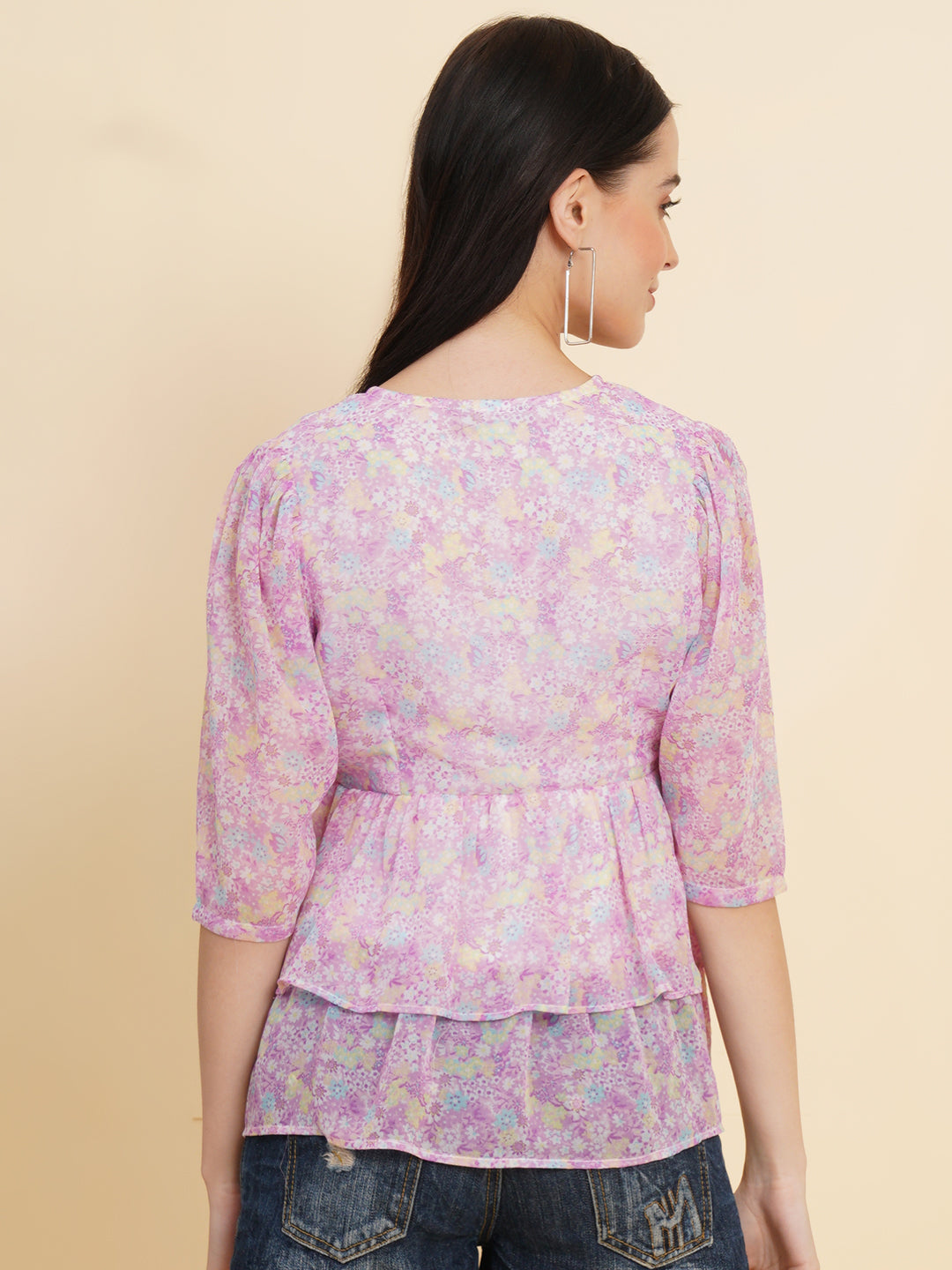  A vibrant purple women's top adorned with beautiful floral patterns. It features double ruffle detailing, creating an elegant and feminine look. The top is fully lined, providing comfort and a smooth fit. Perfect for adding a touch of color and style to any outfit