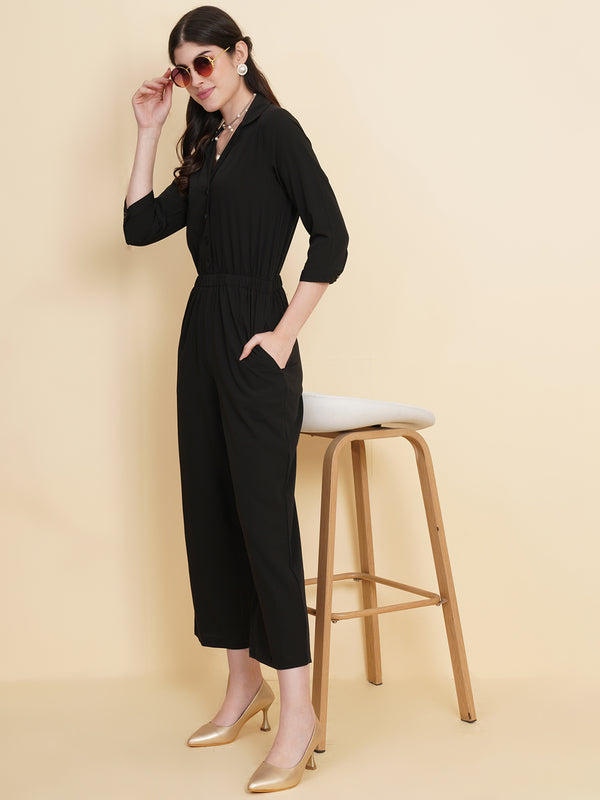 Get ready to make a bold statement with our black formal jumpsuit for women! Tailored in crepe, it features a coat collar with front buttoning and elasticated waist and two side pockets to slip in your essentials. This elegant piece combines sleekness and sophistication, perfect for official and casual wear.