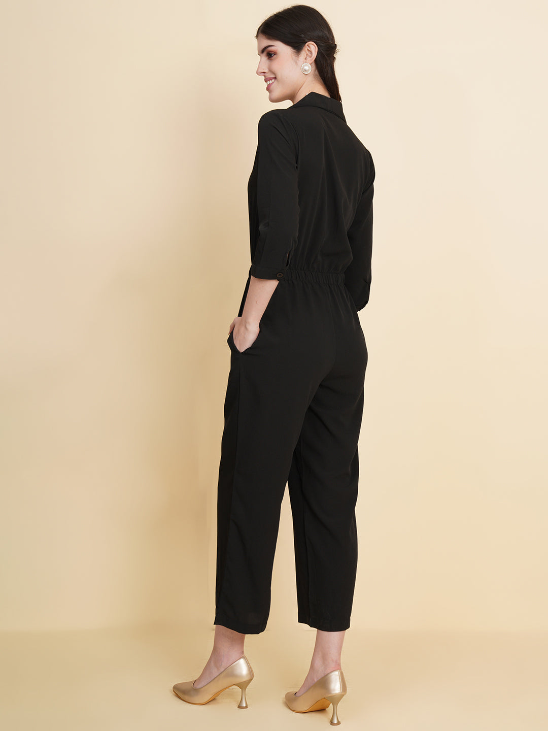 Get ready to make a bold statement with our black formal jumpsuit for women! Tailored in crepe, it features a coat collar with front buttoning and elasticated waist and two side pockets to slip in your essentials. This elegant piece combines sleekness and sophistication, perfect for official and casual wear.