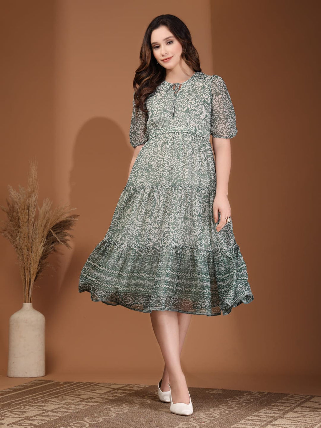 Woman wearing RAASSIO sage green floral printed chiffon tiered midi dress with attached lining Front image