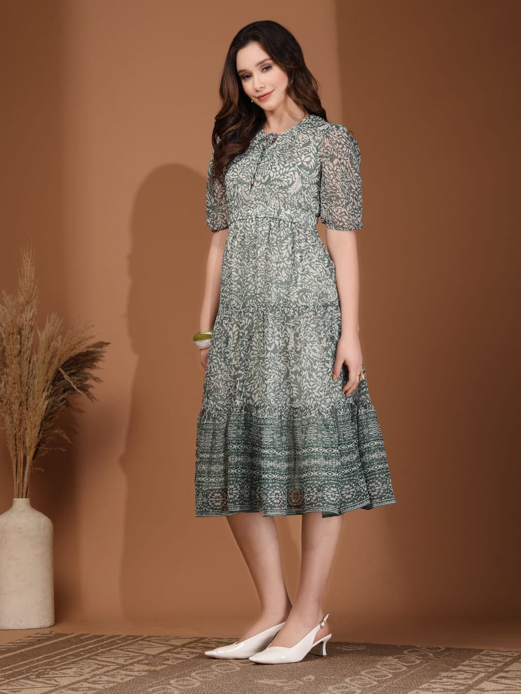 Woman wearing RAASSIO sage green floral printed chiffon tiered midi dress with attached lining side view