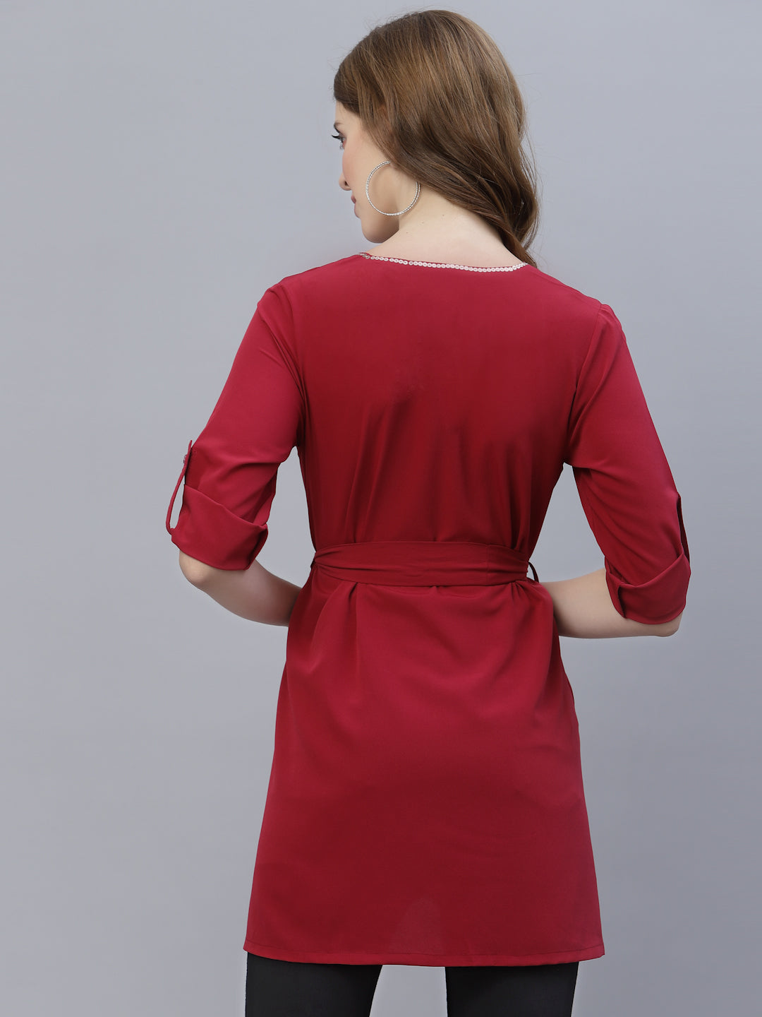 A Burgundy Color V Neck High Low Top With Belt is a stylish and fashionable garment that can be worn for various occasions. The top features a v-neckline, which creates a flattering and feminine look. The high low hemline adds a trendy touch to the design, making it perfect for a night out or a casual day look. The top also comes with a belt that cinches in the waist, creating a more defined silhouette.