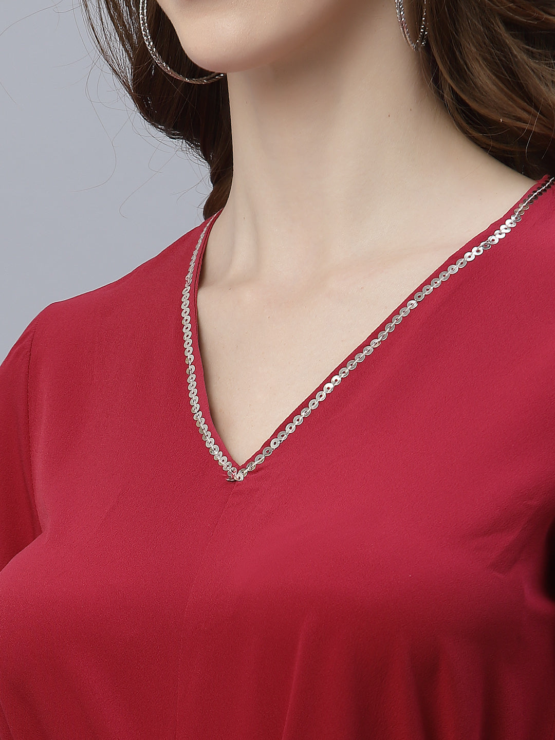 A Burgundy Color V Neck High Low Top With Belt is a stylish and fashionable garment that can be worn for various occasions. The top features a v-neckline, which creates a flattering and feminine look. The high low hemline adds a trendy touch to the design, making it perfect for a night out or a casual day look. The top also comes with a belt that cinches in the waist, creating a more defined silhouette.