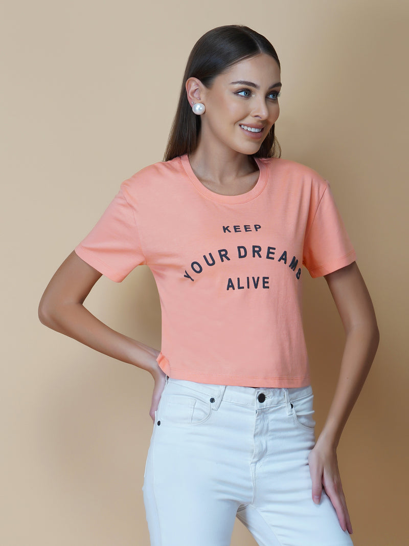 The Peach Color Quote T-Shirt for Women is a trendy and stylish addition to any wardrobe. Made from soft, breathable cotton fabric, this T-shirt is perfect for hot weather and provides excellent comfort and flexibility.  The shirt features a beautiful peach color, which adds a touch of femininity and sophistication. The shirt is designed with a simple round neck and short sleeves, making it a versatile option for any outfit.
