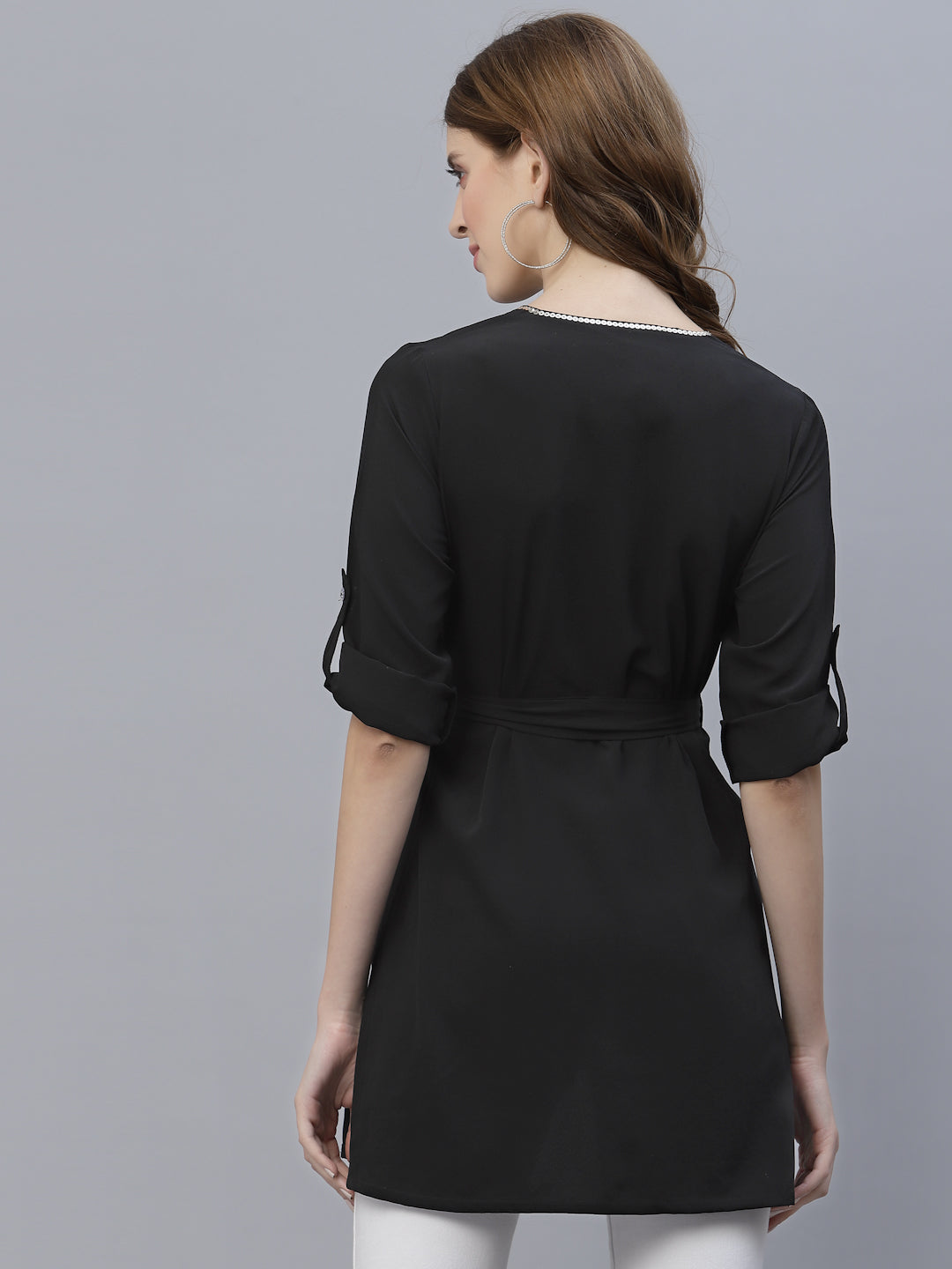 A Black Color V Neck High Low Top With Belt is a stylish and fashionable garment that can be worn for various occasions. The top features a v-neckline, which creates a flattering and feminine look. The high low hemline adds a trendy touch to the design, making it perfect for a night out or a casual day look. The top also comes with a belt that cinches in the waist, creating a more defined silhouette.