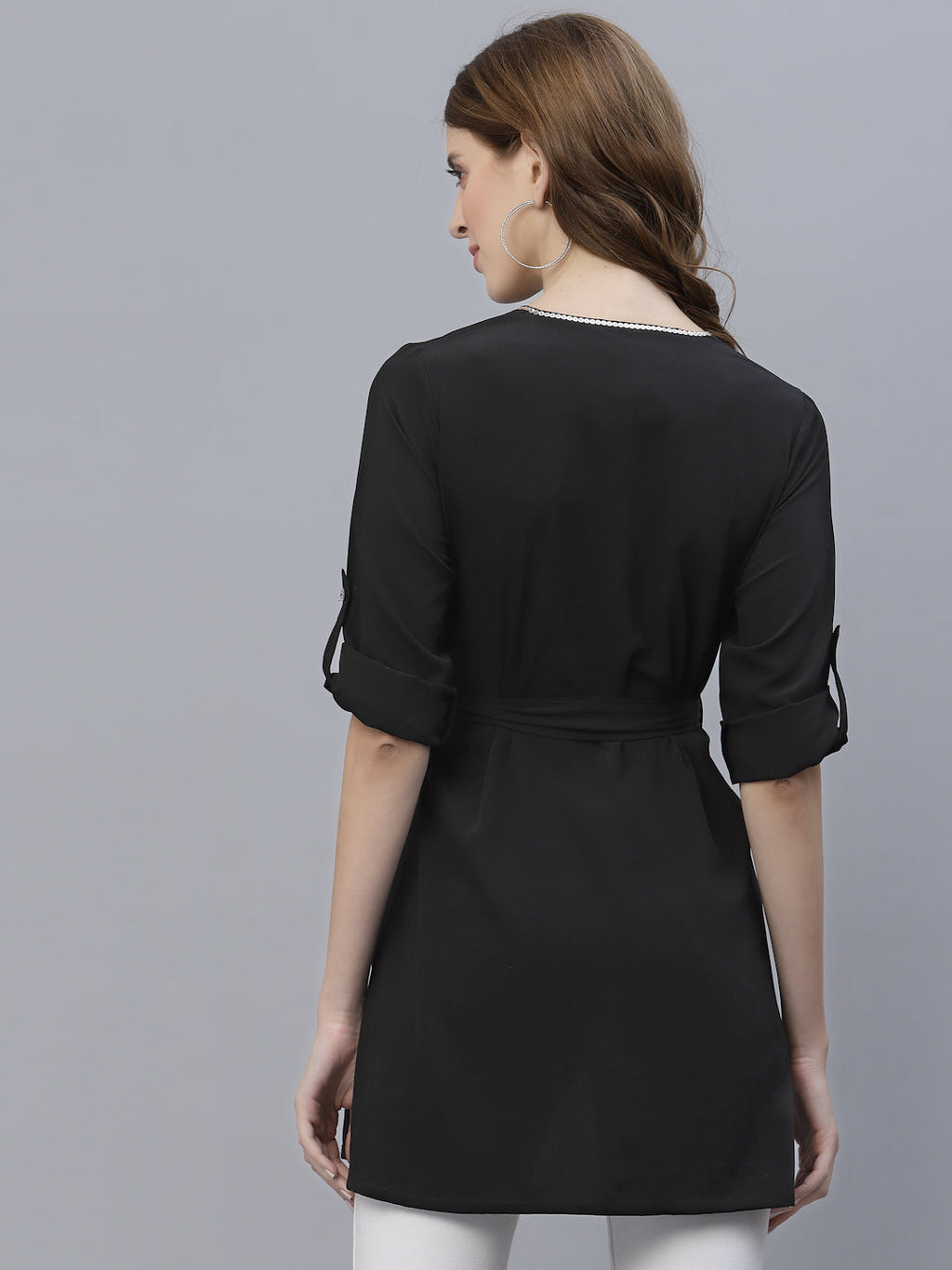 A Black Color V Neck High Low Top With Belt is a stylish and fashionable garment that can be worn for various occasions. The top features a v-neckline, which creates a flattering and feminine look. The high low hemline adds a trendy touch to the design, making it perfect for a night out or a casual day look. The top also comes with a belt that cinches in the waist, creating a more defined silhouette.