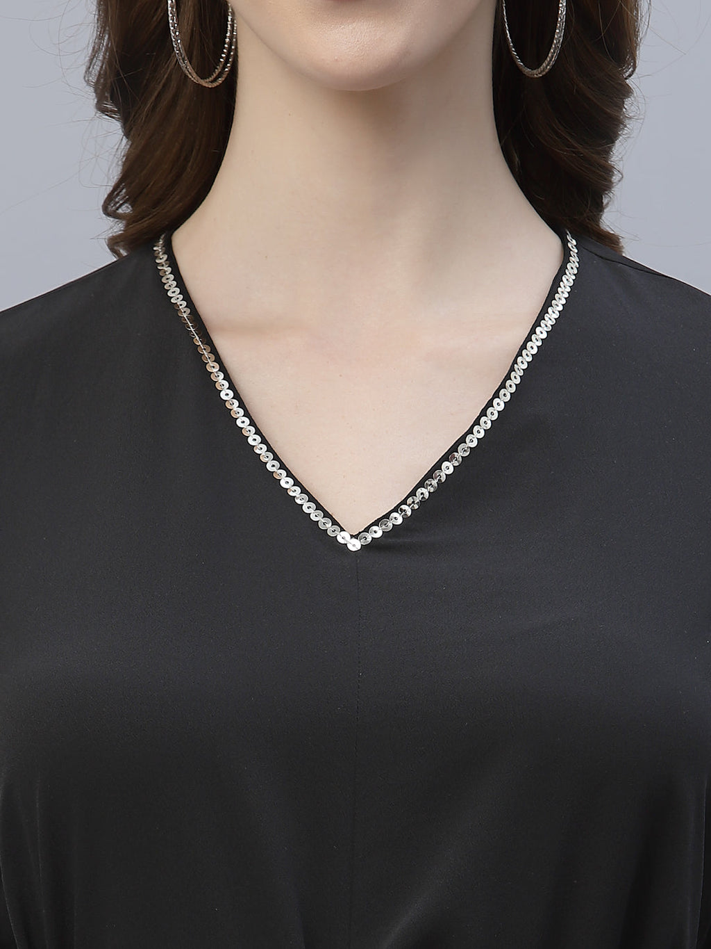 A Black Color V Neck High Low Top With Belt is a stylish and fashionable garment that can be worn for various occasions. The top features a v-neckline, which creates a flattering and feminine look. The high low hemline adds a trendy touch to the design, making it perfect for a night out or a casual day look. The top also comes with a belt that cinches in the waist, creating a more defined silhouette.