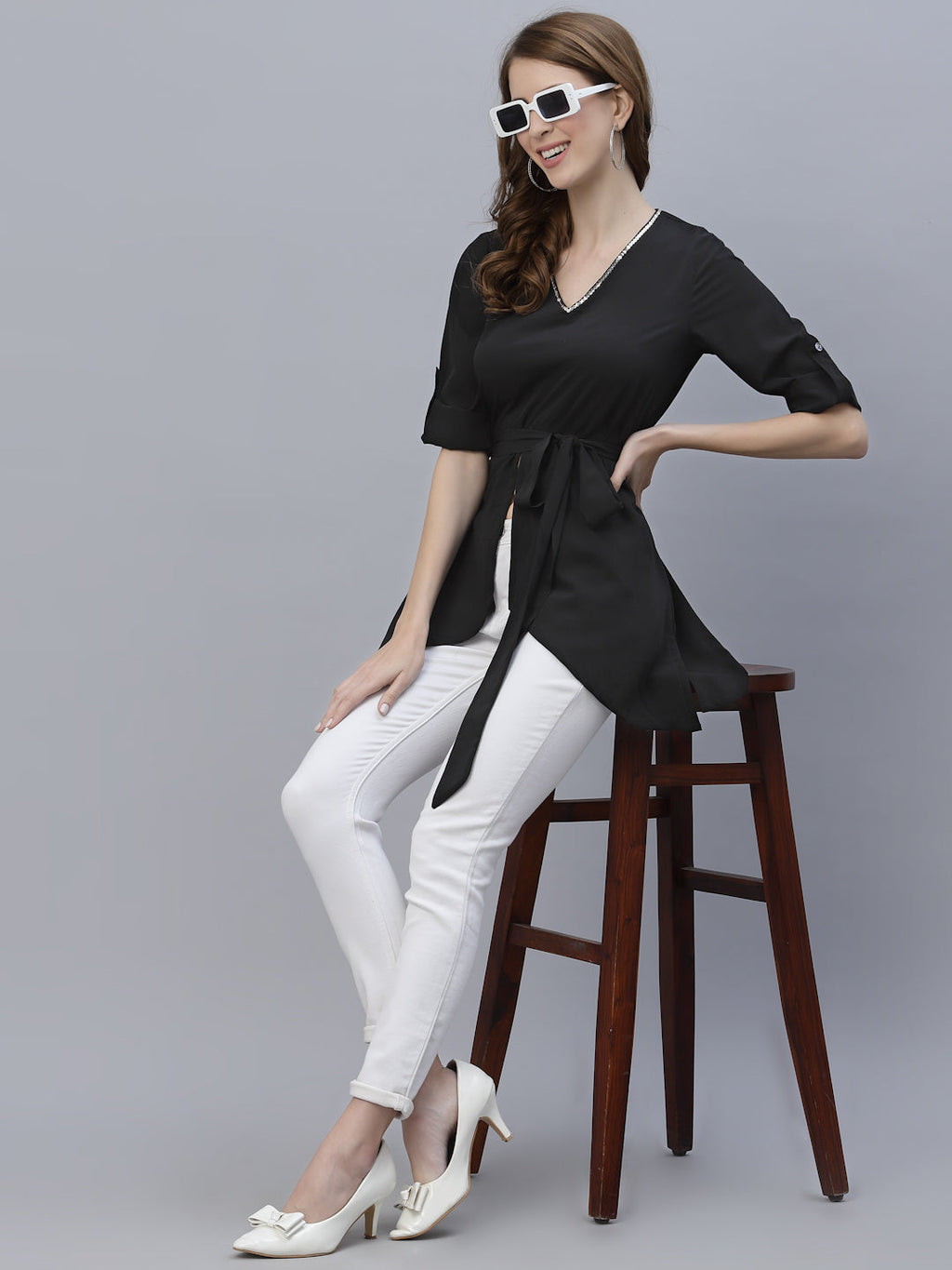 A Black Color V Neck High Low Top With Belt is a stylish and fashionable garment that can be worn for various occasions. The top features a v-neckline, which creates a flattering and feminine look. The high low hemline adds a trendy touch to the design, making it perfect for a night out or a casual day look. The top also comes with a belt that cinches in the waist, creating a more defined silhouette.