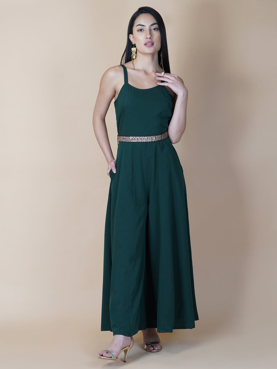 Elevate your style game with our stunning green fit and flare jumpsuit for women! This head-turning piece features a beautifully seerate embellished belt that cinches your waist and adds a touch of glamour.   Zip Closure at Back & 2 side Pockets to slip in your valuables !   Fabric : Crepe  Colour : Bottle Green