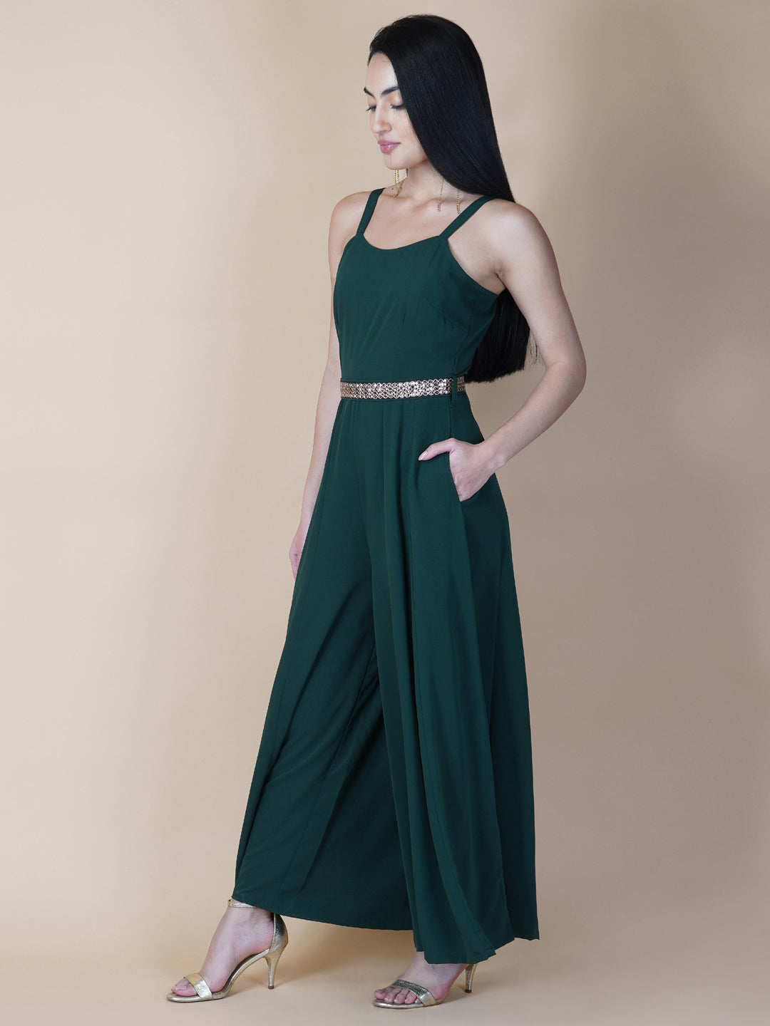Elevate your style game with our stunning green fit and flare jumpsuit for women! This head-turning piece features a beautifully seerate embellished belt that cinches your waist and adds a touch of glamour.   Zip Closure at Back & 2 side Pockets to slip in your valuables !   Fabric : Crepe  Colour : Bottle Green