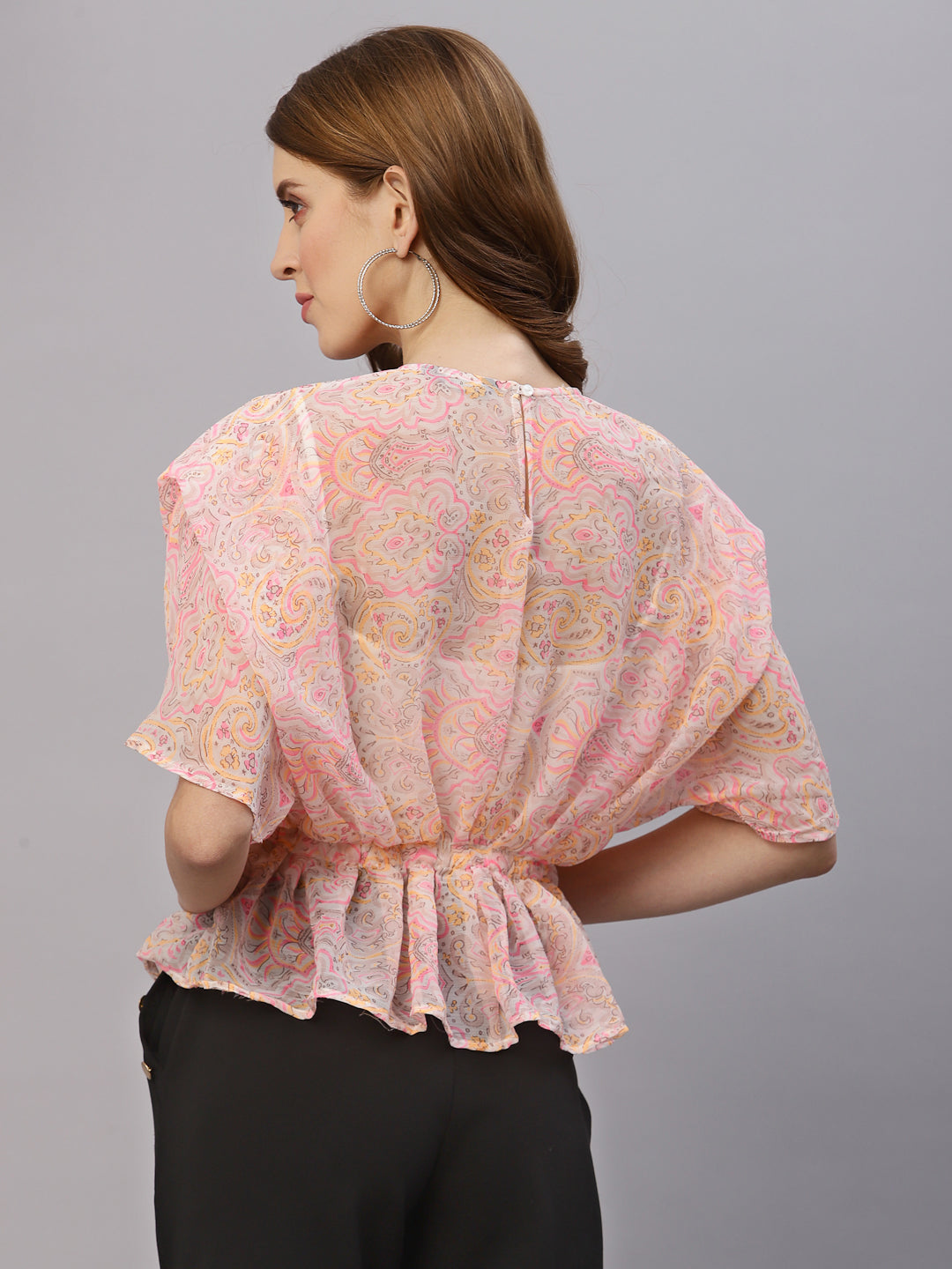 This top features a lightweight and flowy chiffon material that drapes beautifully over the body. The oversized design allows for a comfortable and relaxed fit, while the attached cami provides extra coverage and support. The embellished waist band adds a touch of sparkle and elegance, accentuating the waistline and creating a flattering silhouette. This top is perfect for a variety of occasions, from casual outings to formal events. Pair it with skinny jeans and heels for a chic and stylish look.