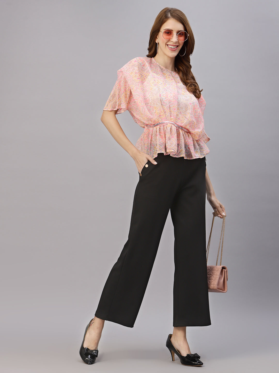 This top features a lightweight and flowy chiffon material that drapes beautifully over the body. The oversized design allows for a comfortable and relaxed fit, while the attached cami provides extra coverage and support. The embellished waist band adds a touch of sparkle and elegance, accentuating the waistline and creating a flattering silhouette. This top is perfect for a variety of occasions, from casual outings to formal events. Pair it with skinny jeans and heels for a chic and stylish look.