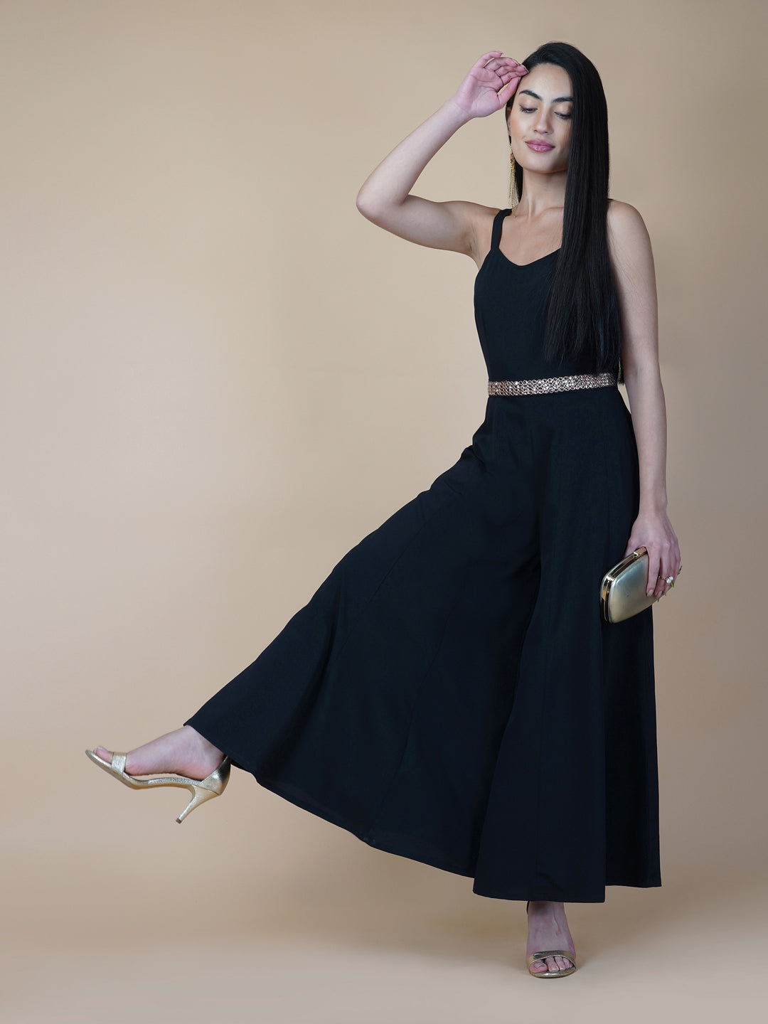 This black solid fit and flare women jumpsuit with an attached belt is a fashionable one-piece garment that combines the comfort of pants with the elegance of a dress. This jumpsuit features a fitted top that flares out into wide-leg pants, creating a flattering silhouette that accentuates the waist and elongates the legs.